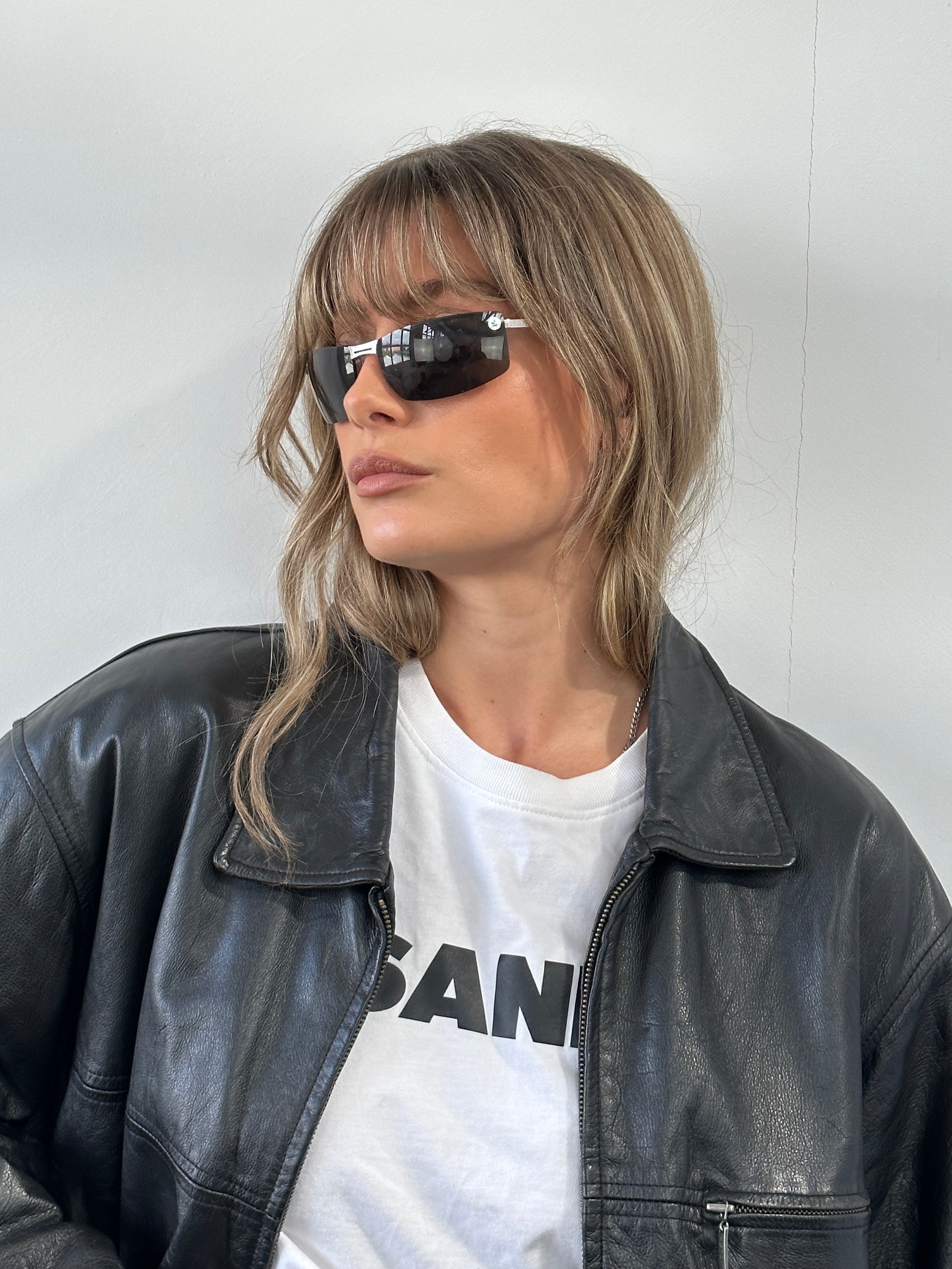 Christian Dior 2000s rimless sunglasses with sleek black frames and tinted lenses, stylish eyewear for a modern look.