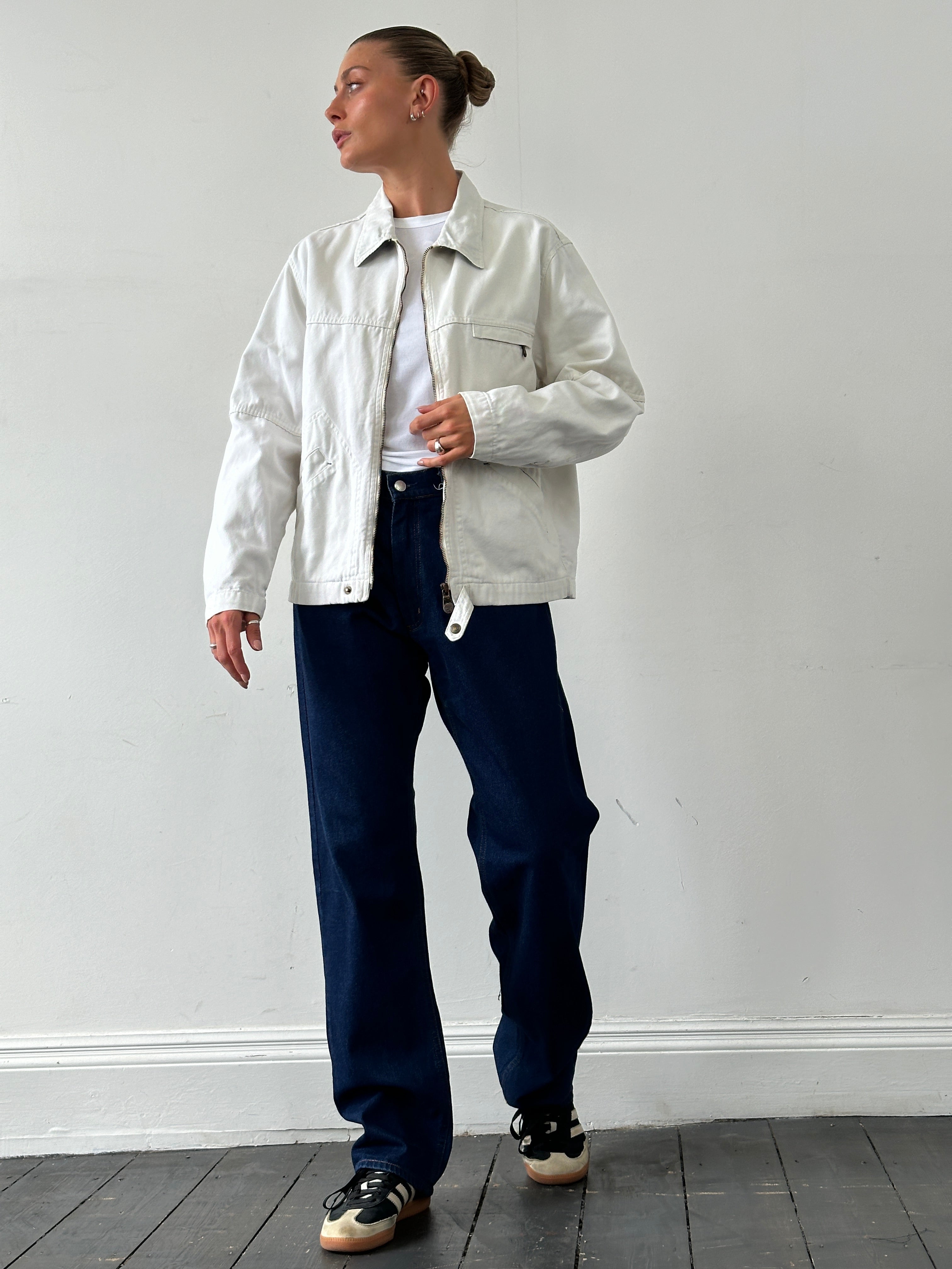 Levi’s cotton zip-up bomber jacket in size L, navy blue with ribbed cuffs and collar, front zip closure, and side pockets.