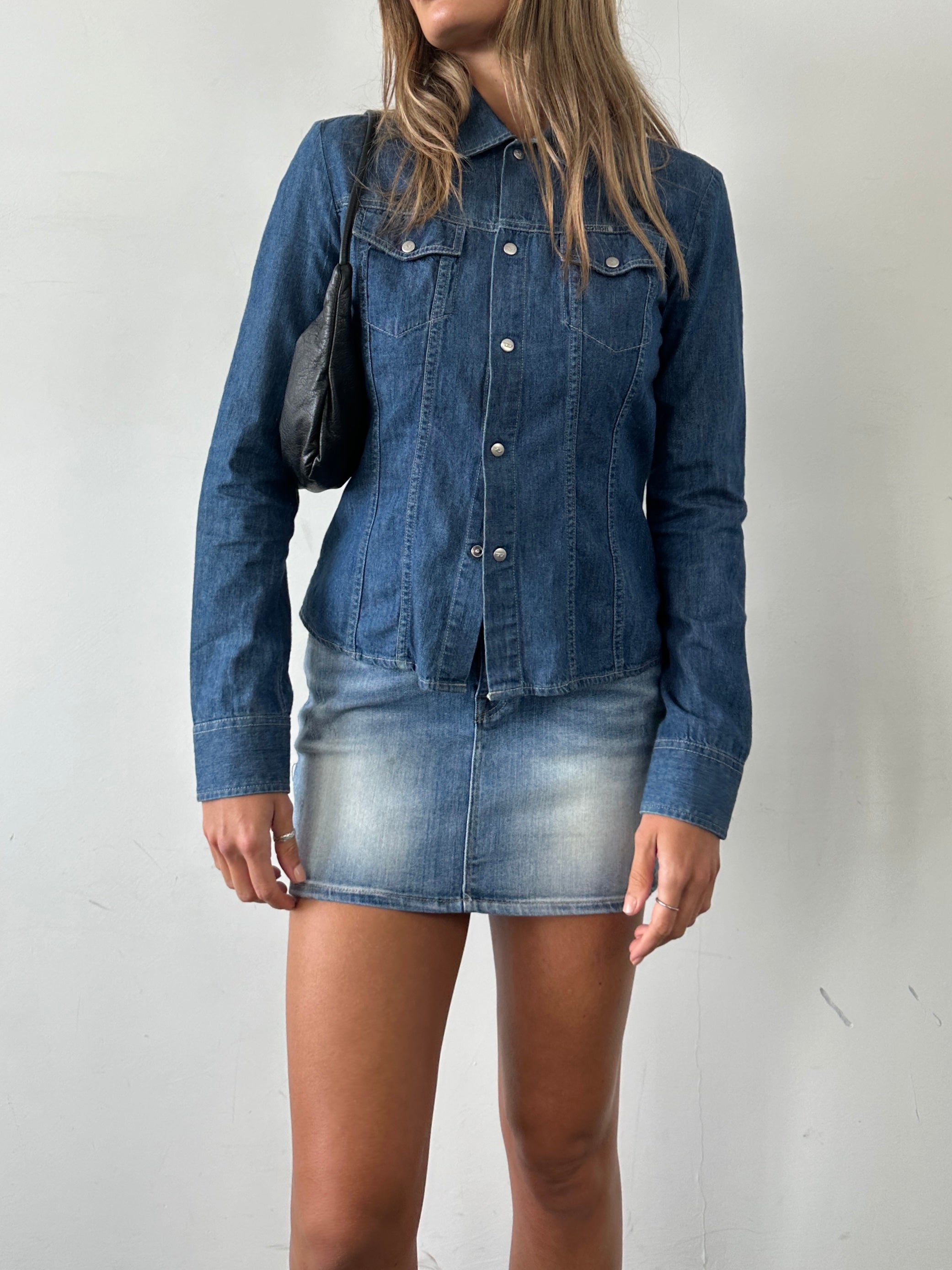 Diesel fitted denim shirt in size small, featuring classic blue denim fabric and button-up front.