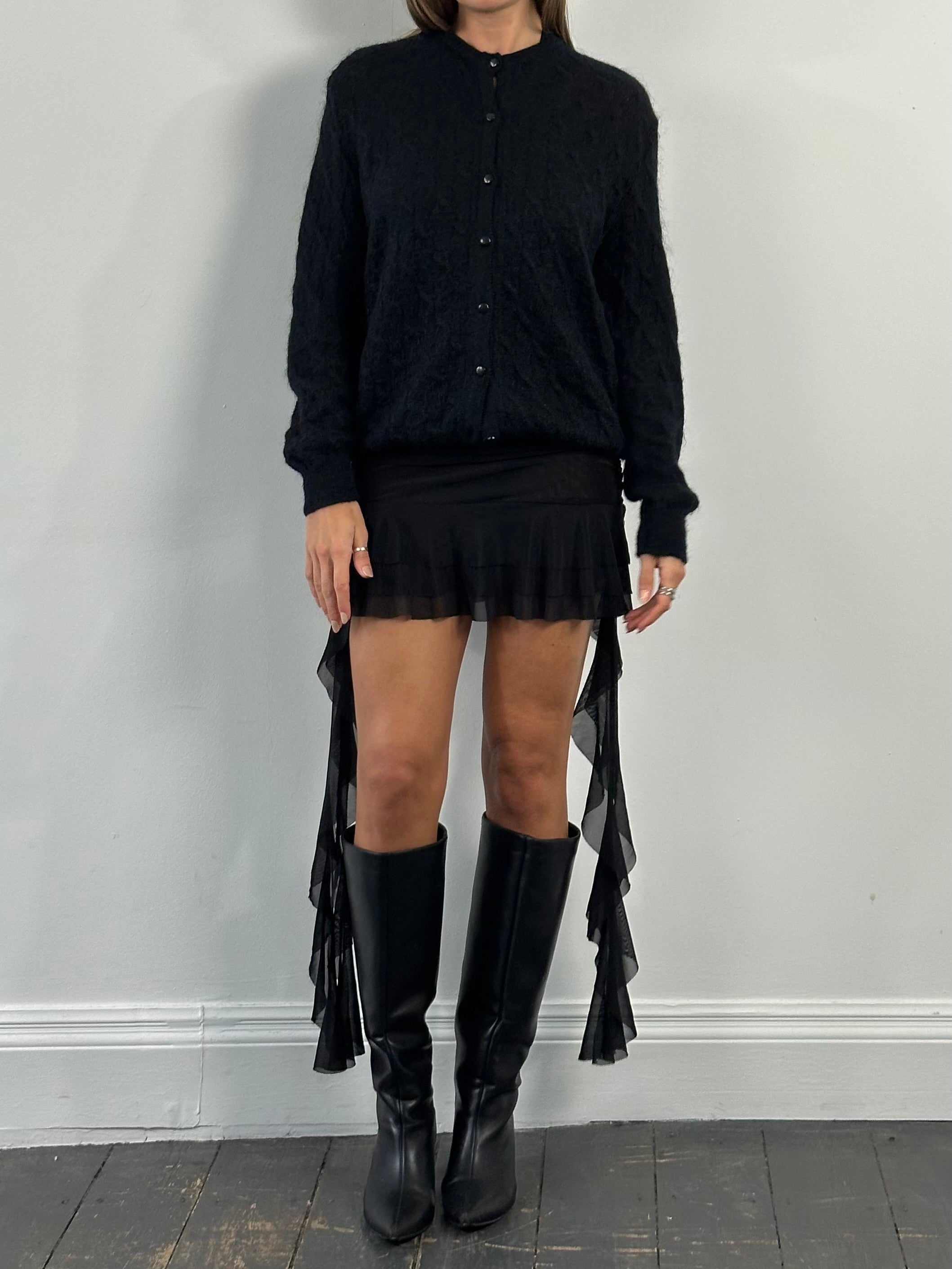 Vintage 1990s layered ruffle mini skirt in size S, featuring a playful, textured fabric with a flared silhouette.