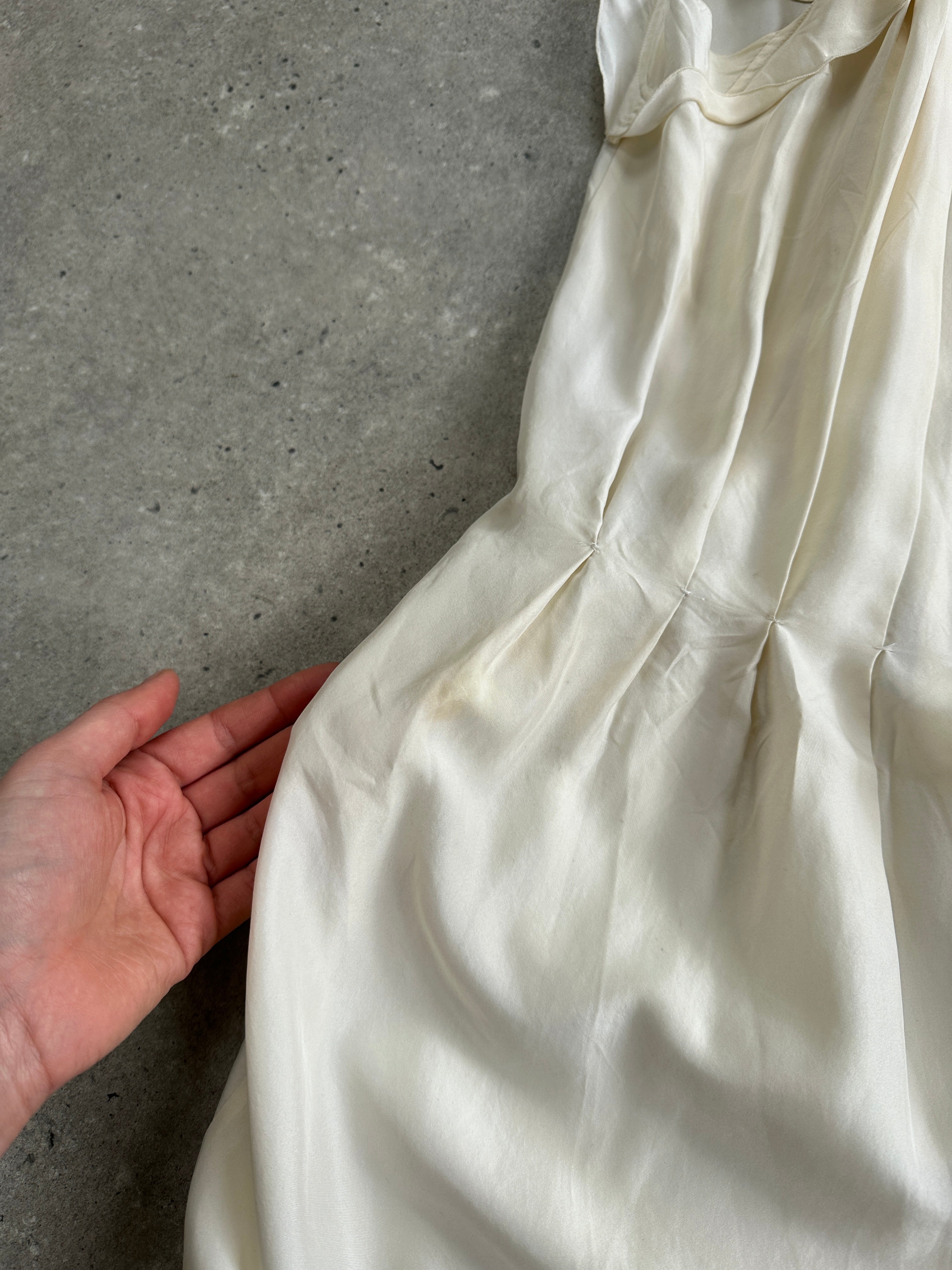 Prada 2012 pure silk pleated slip dress in size large, shown hanging with soft fabric details and elegant design.