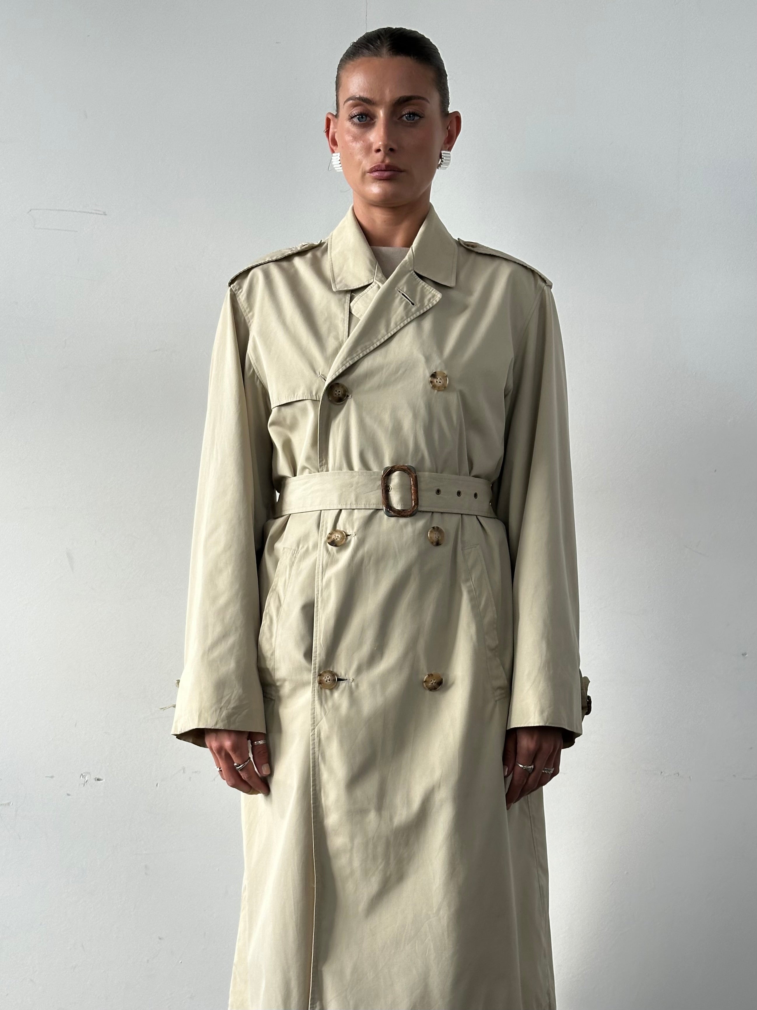 Christian Dior Paris cotton double-breasted belted trench coat in cream, displayed on a hanger, stylish and classic design.