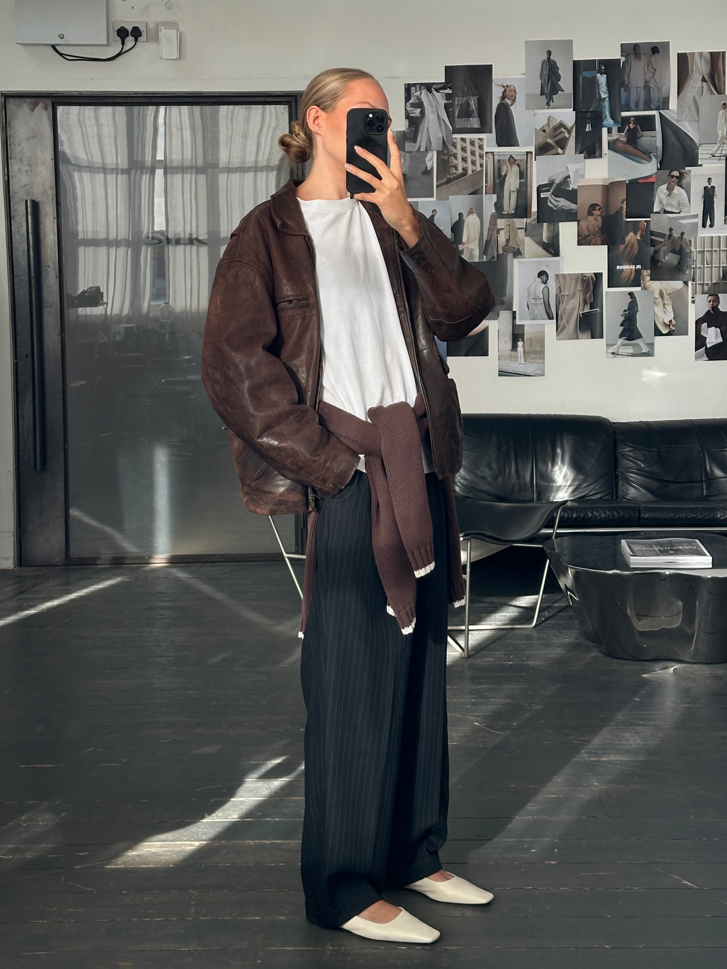 Vintage French 1980s boxy leather jacket in aged black leather, featuring a classic vintage style and structured fit.