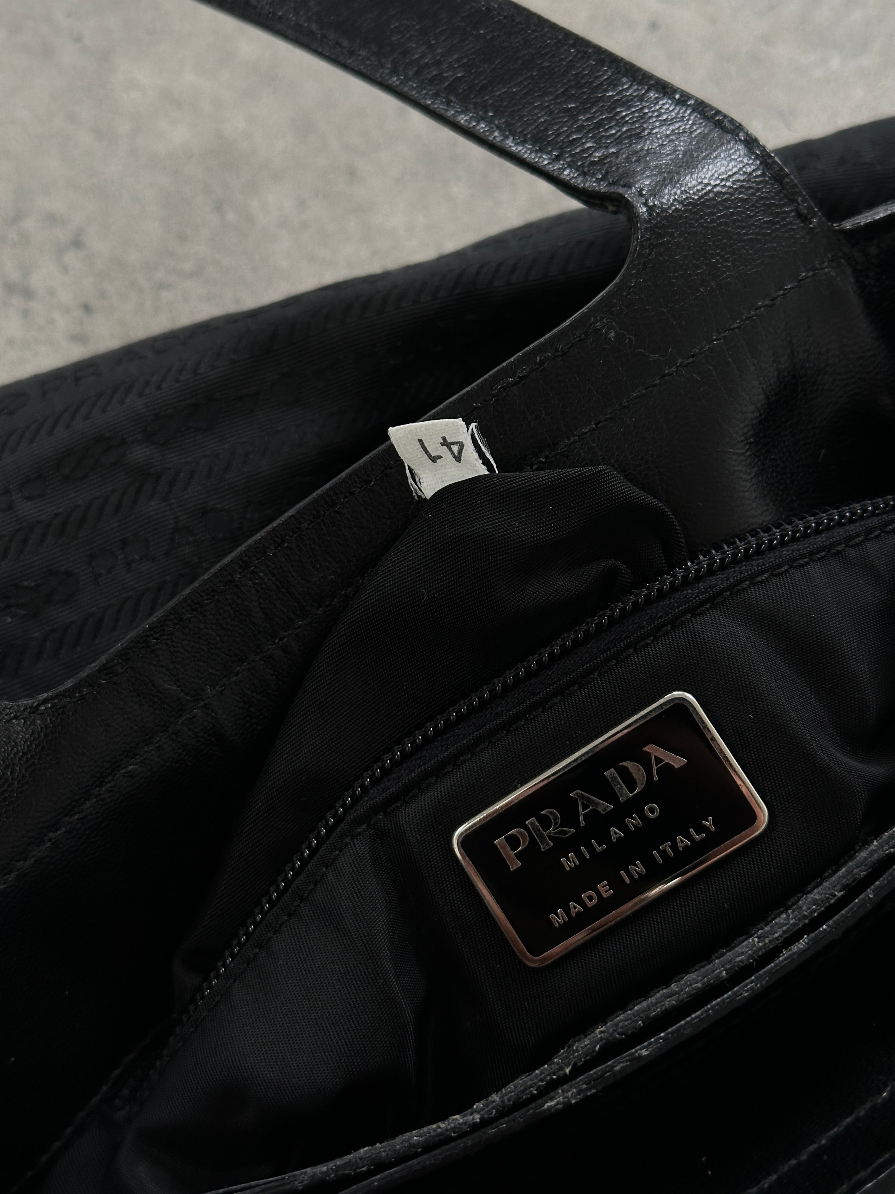 Prada 1990s Tessuto Monogram handbag with leather accents, featuring the classic Prada logo and structured design.