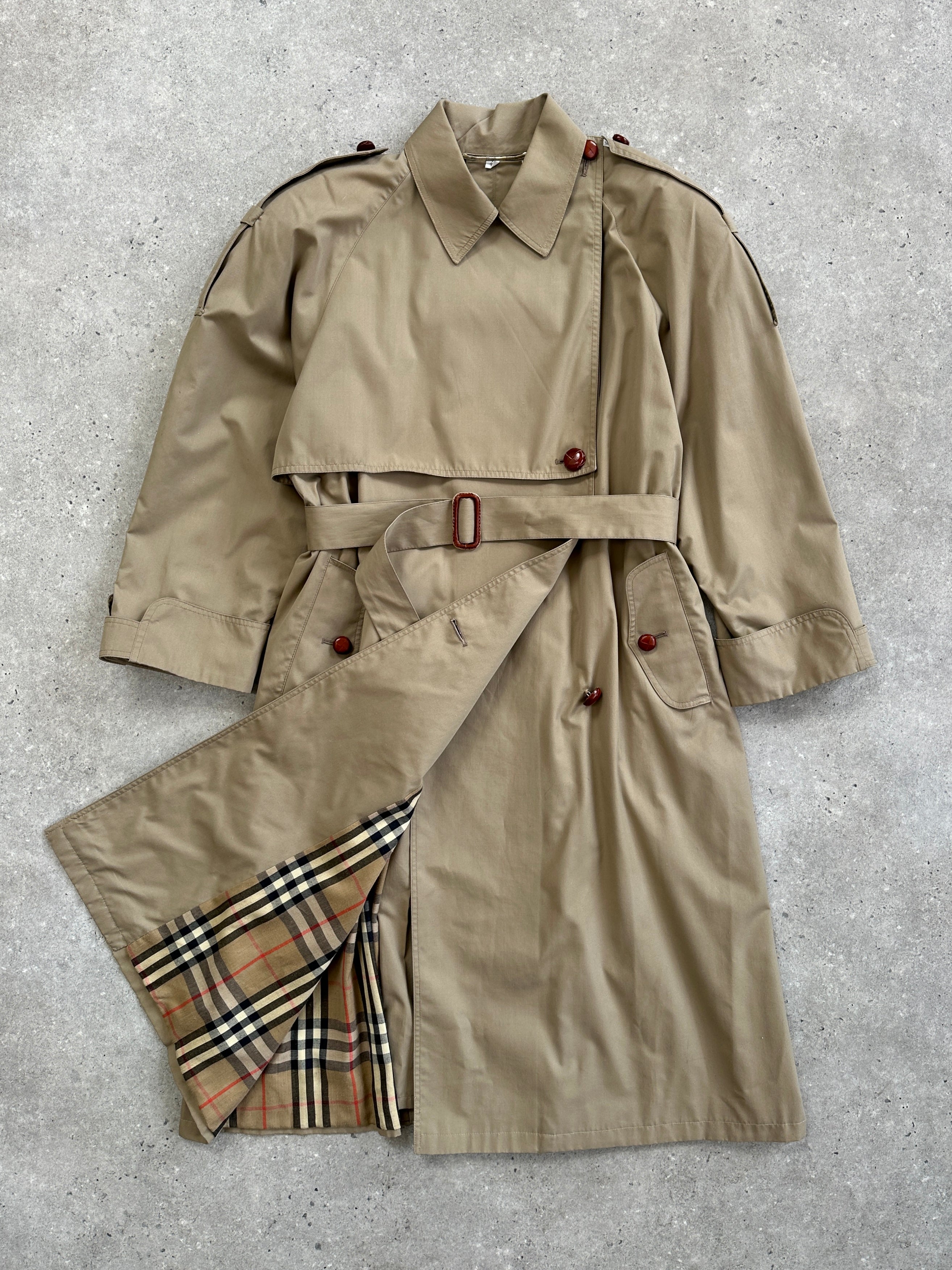 Vintage 1980s Nova Check belted trench coat in size M, featuring classic design and checkered pattern, displayed on a hanger.