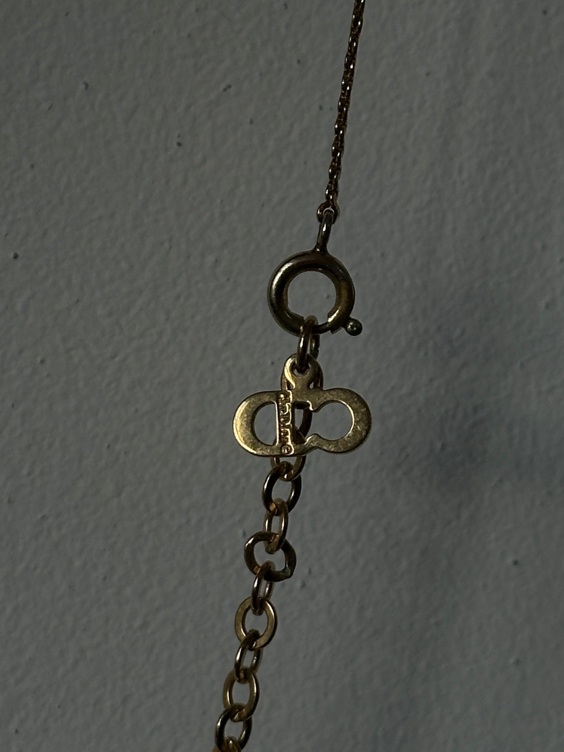Christian Dior 16-inch gold plated logo pendant necklace with a sleek chain and elegant Dior branding.