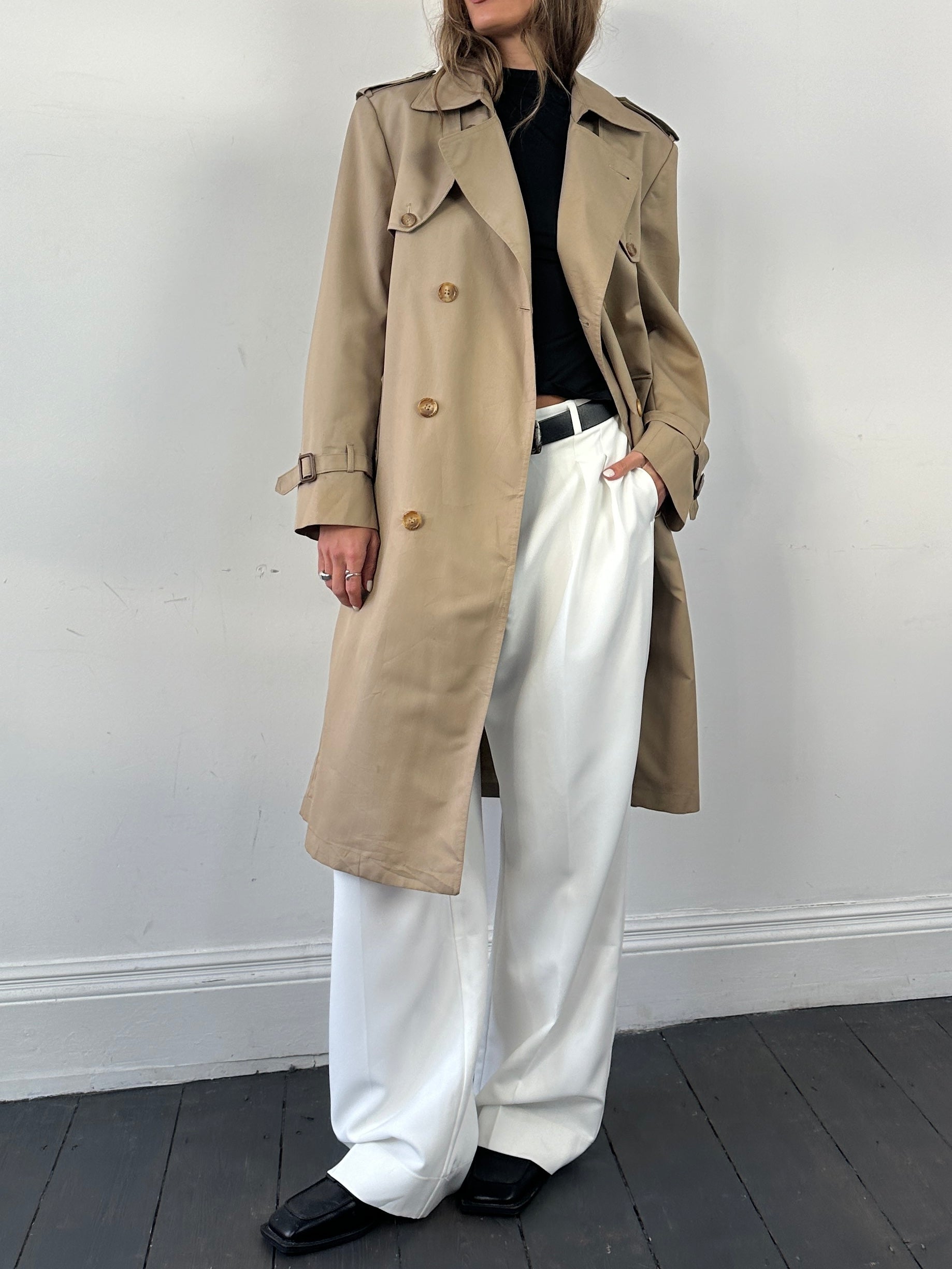 Christian Dior double-breasted cotton trench coat with belted waist, shown in a classic design and neutral color.