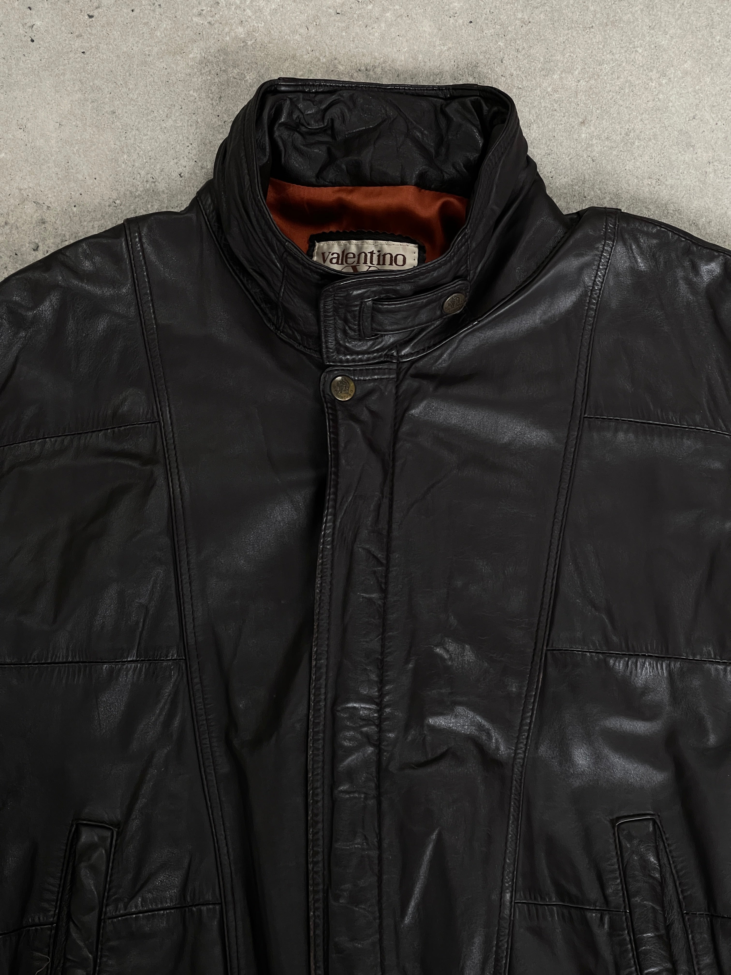 Valentino 1990s high neck leather bomber jacket in black, with detailed stitching and a sleek, fitted silhouette.