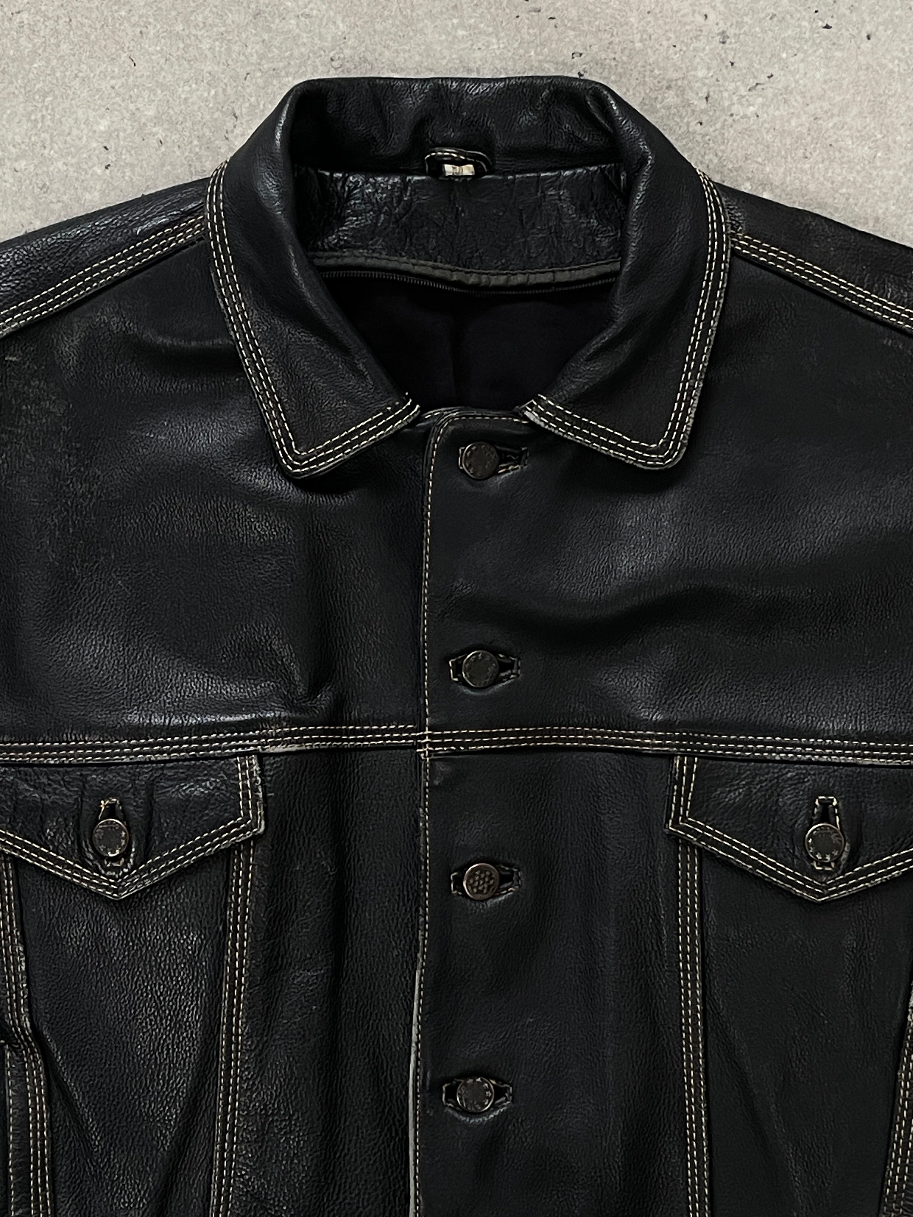 Vintage 1990s leather boxy jacket in black with a classic collar and button closure, styled with long sleeves and a cropped fit.