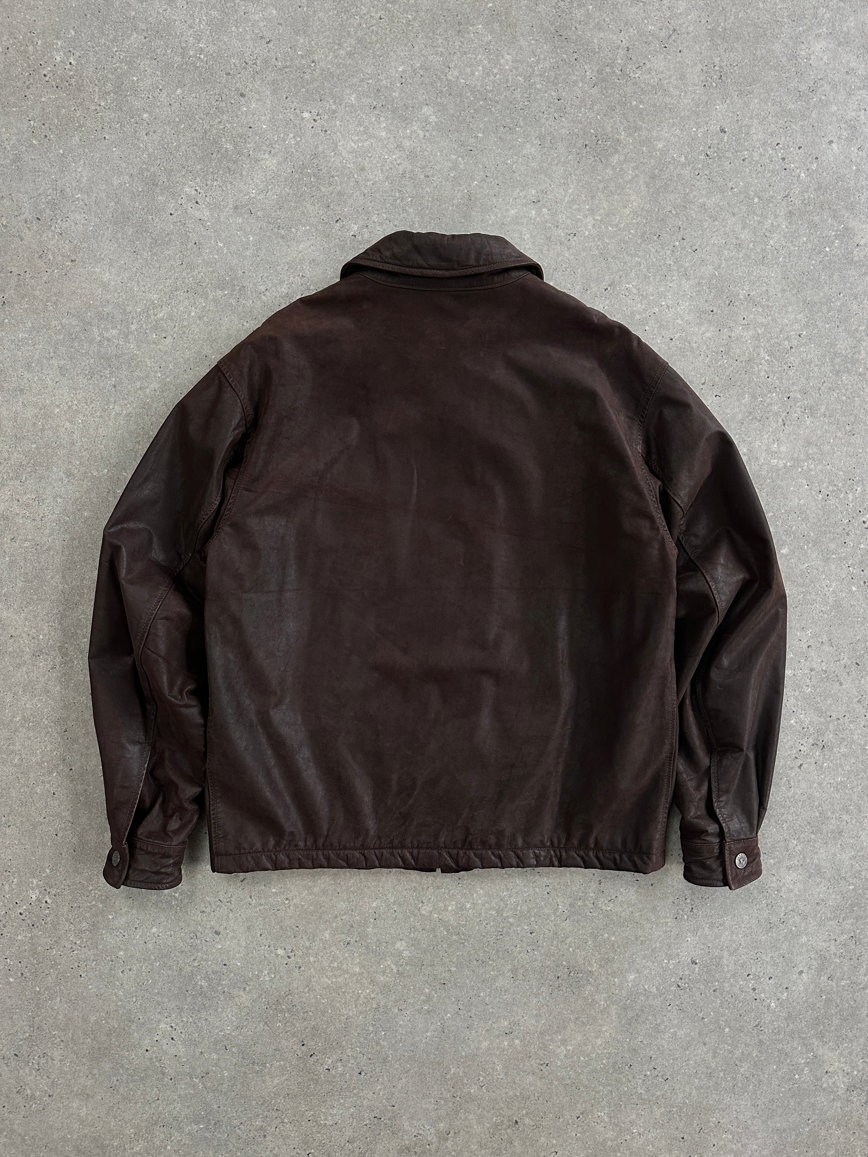 Versace Jeans Couture 1990s boxy leather jacket in black, with classic design and structured fit, displayed on a hanger.