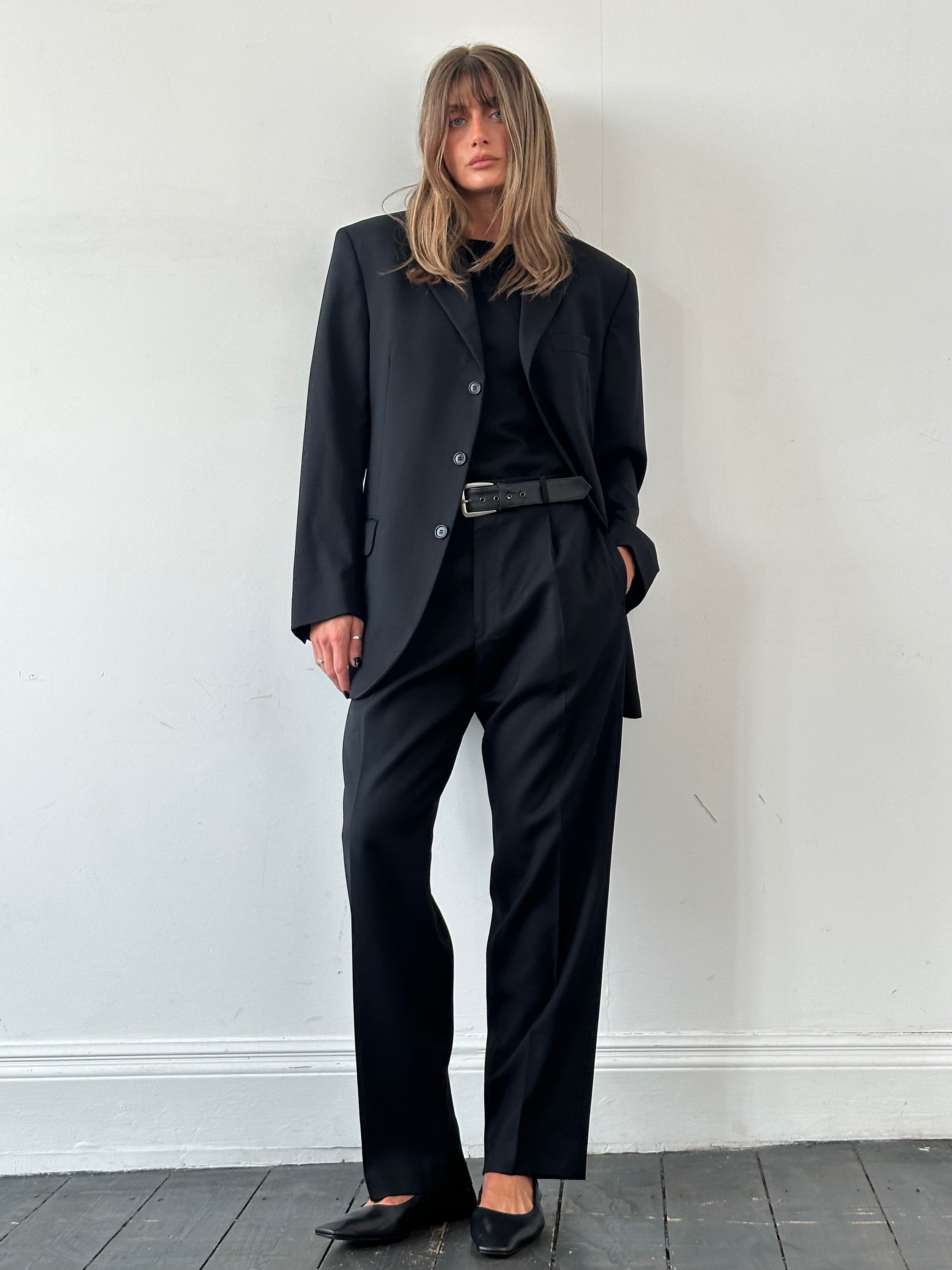 Yves Saint Laurent Pour Homme wool single-breasted suit in size 42R/W34, shown as a tailored jumpsuit in classic dark fabric.