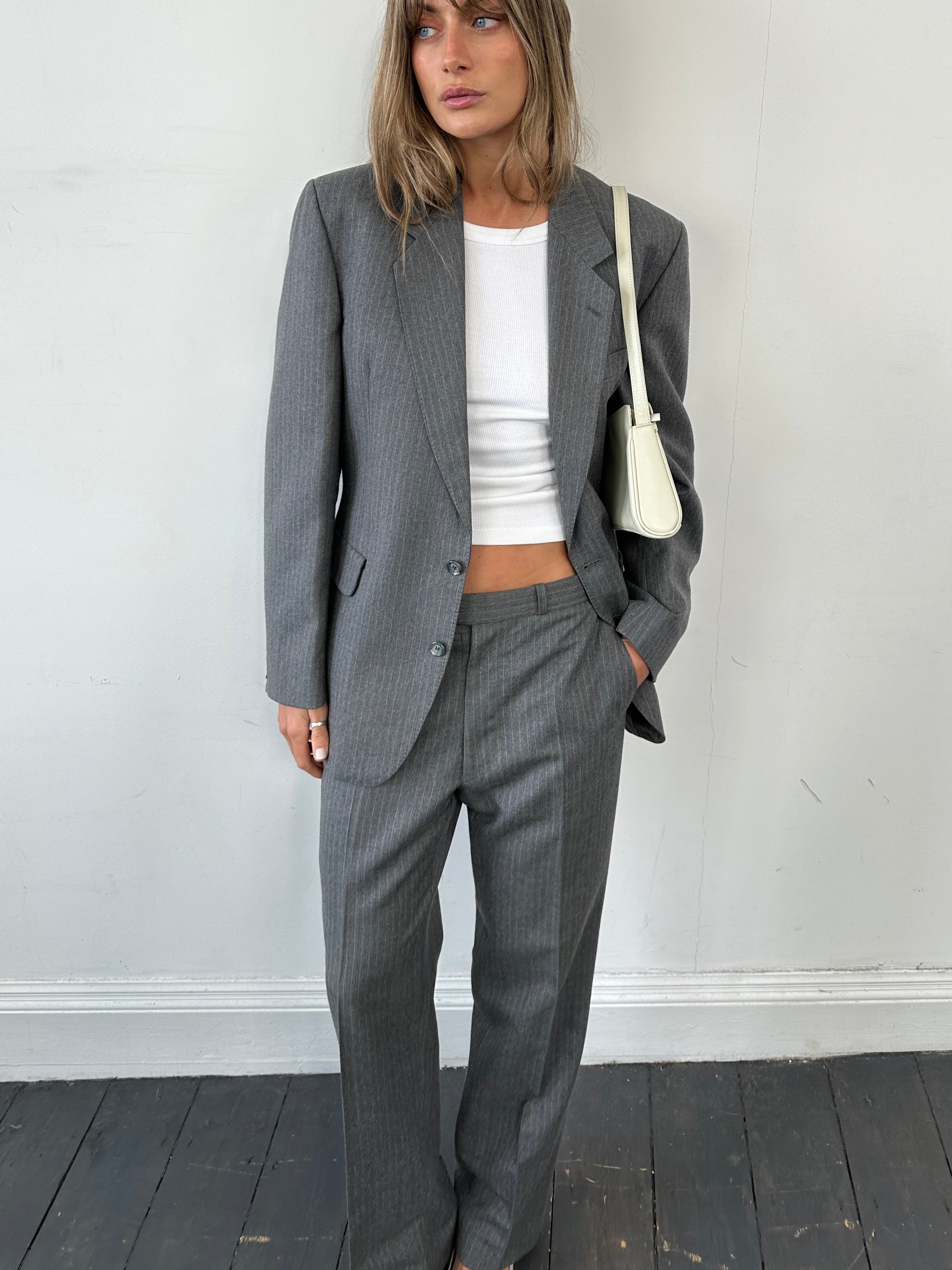 Vintage British pinstripe wool jumpsuit, single-breasted suit in size 42R/W32, featuring classic vintage tailoring.