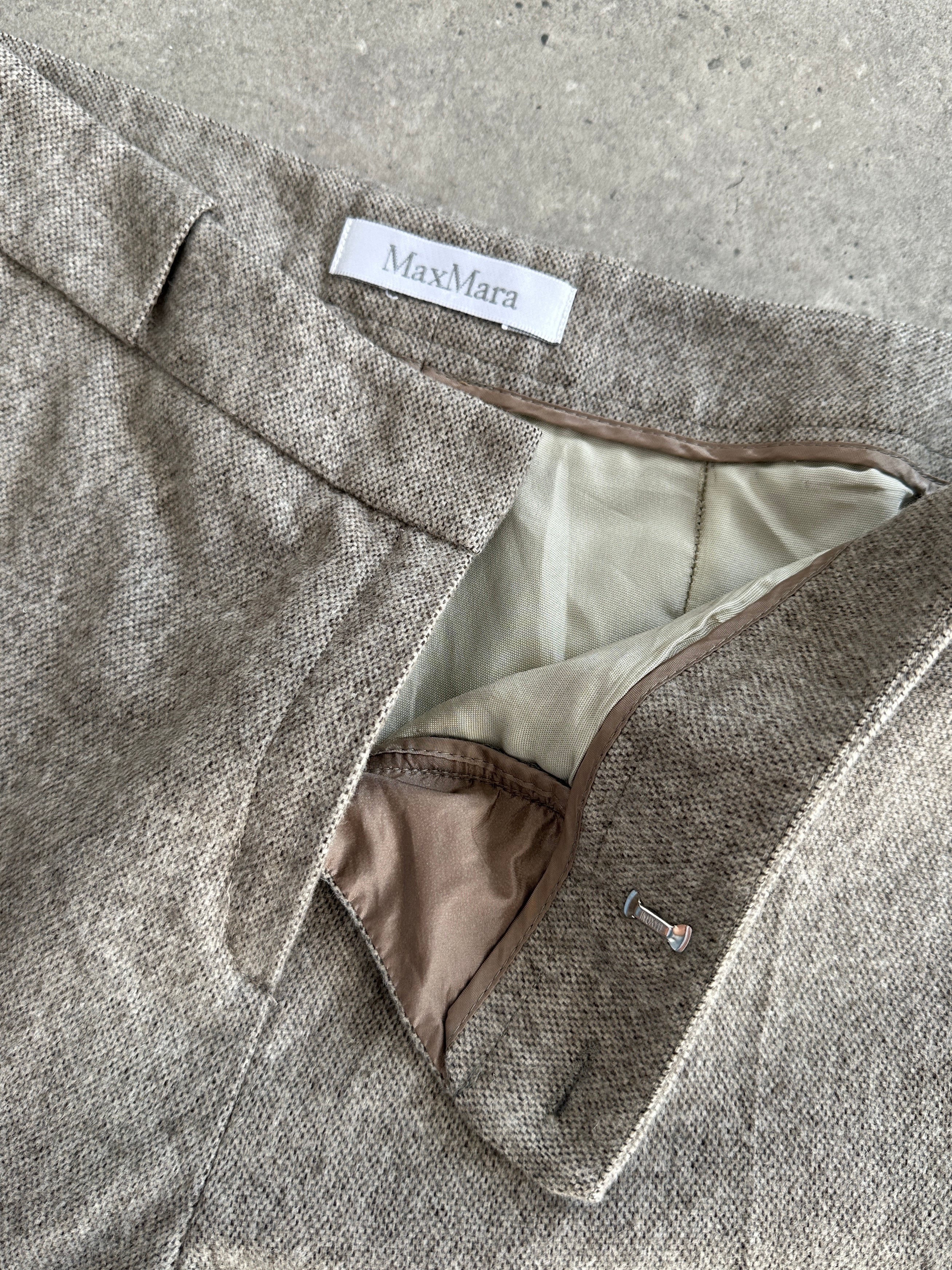 Max Mara wool wide-leg high-waisted trousers in neutral fabric, displayed on a hanger with a clean background.