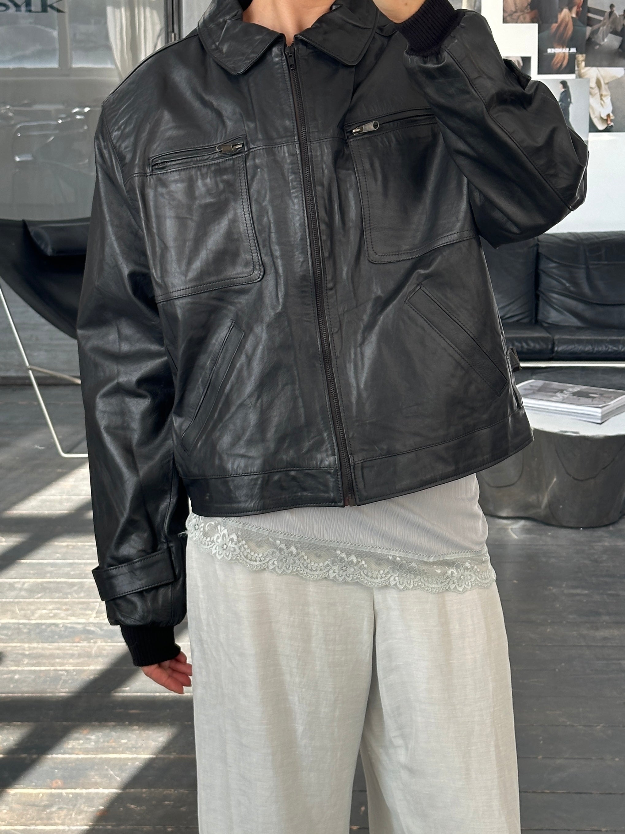 Vintage 1990s boxy cropped leather jacket in black, featuring a classic design and silver hardware, size large.