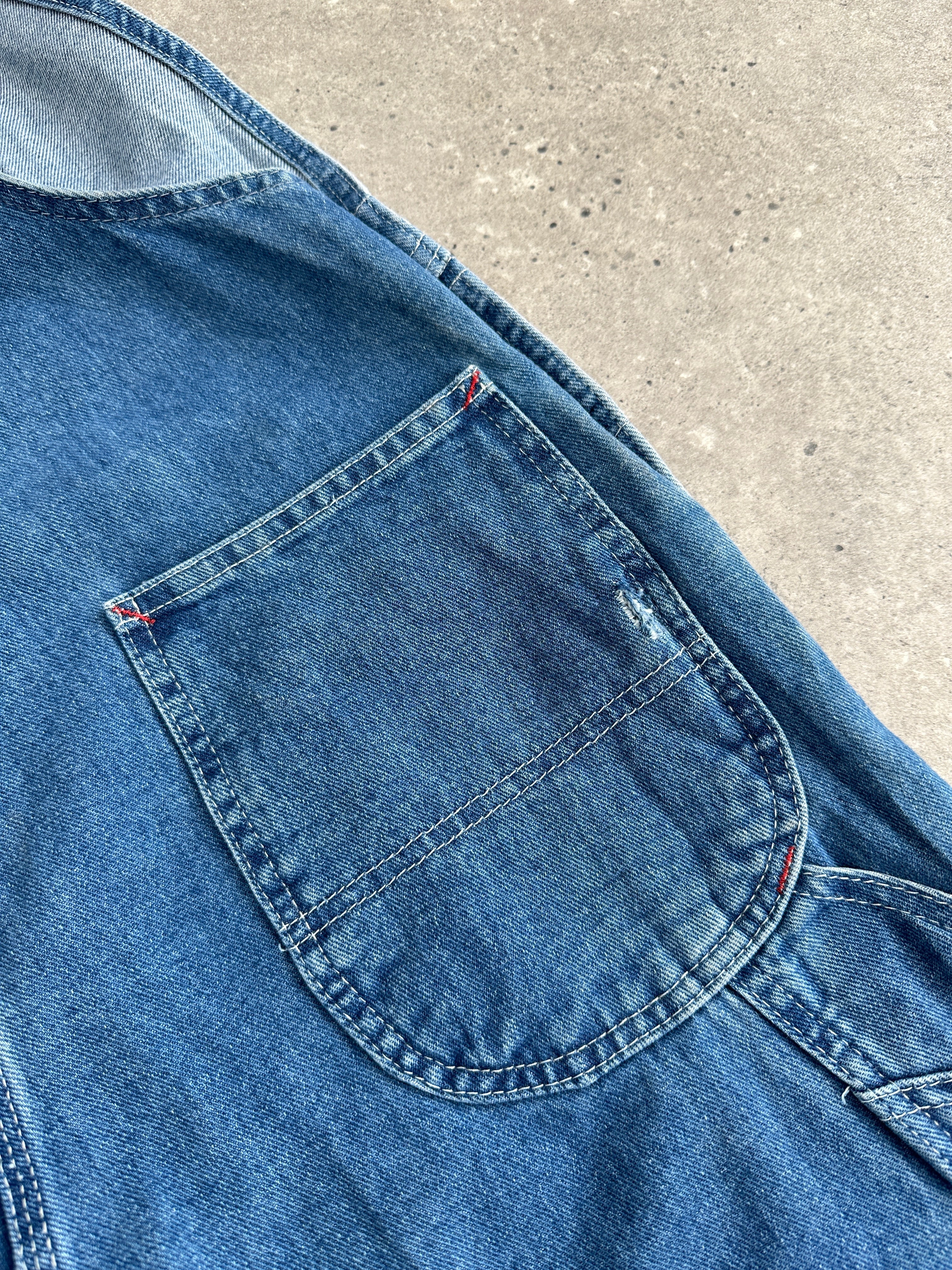Dickies pure cotton denim dungarees in medium size, featuring classic blue fabric and adjustable shoulder straps.