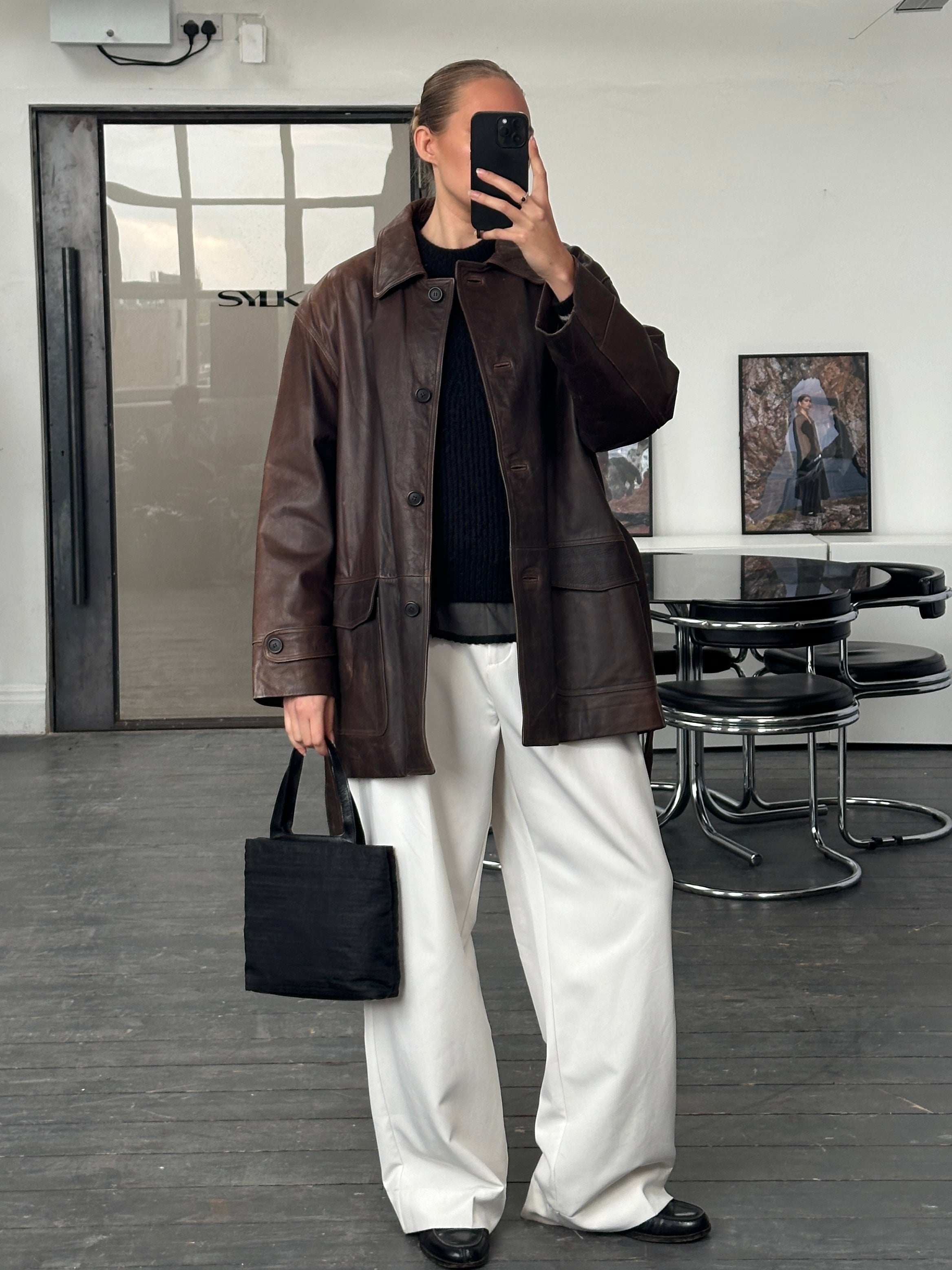 Italian vintage 1990s belted leather jacket in size XL, classic aged leather design by Vintage brand.
