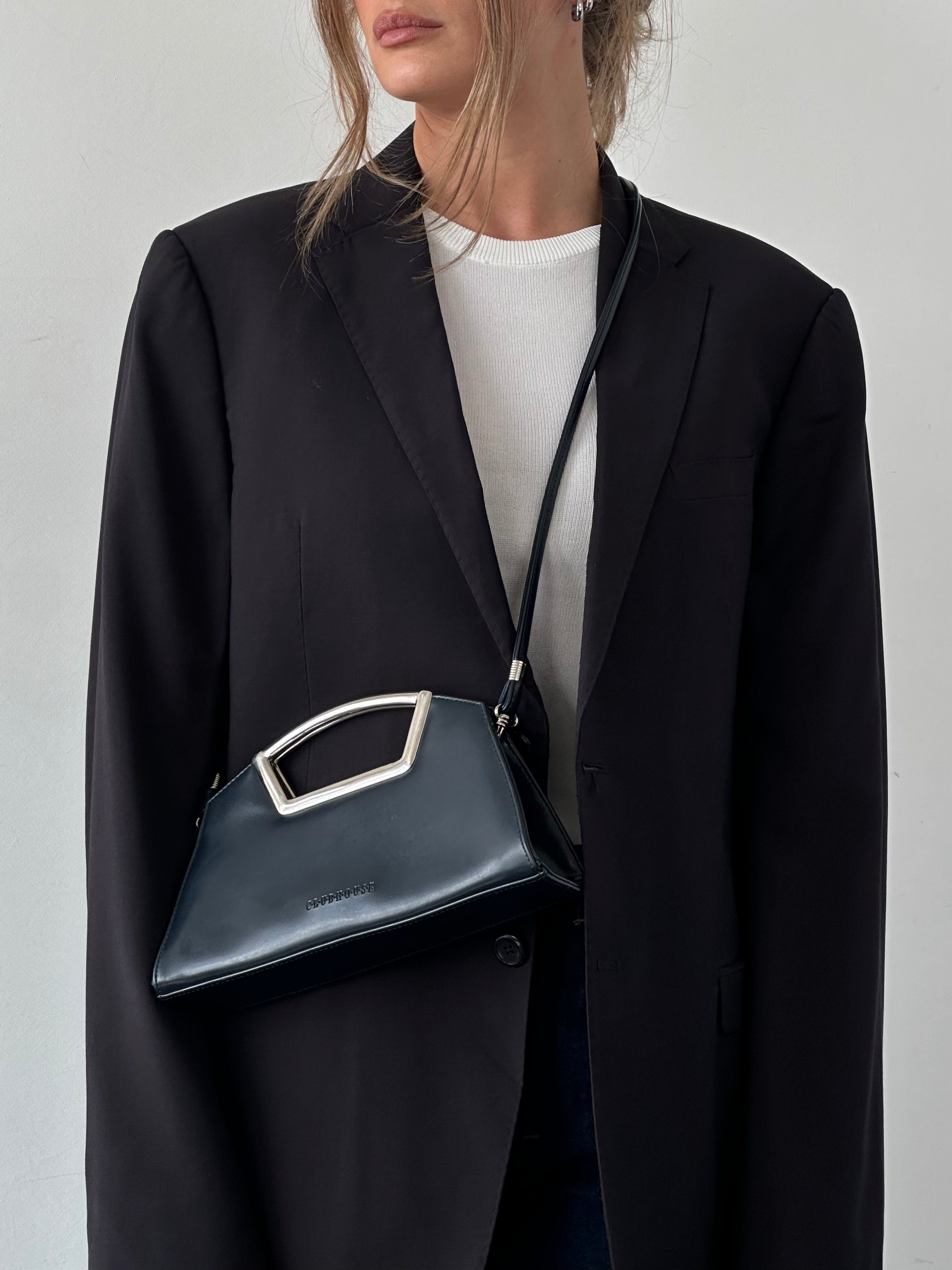 Vintage leather chrome crossbody clutch bag with adjustable strap and classic design, perfect for stylish everyday use.