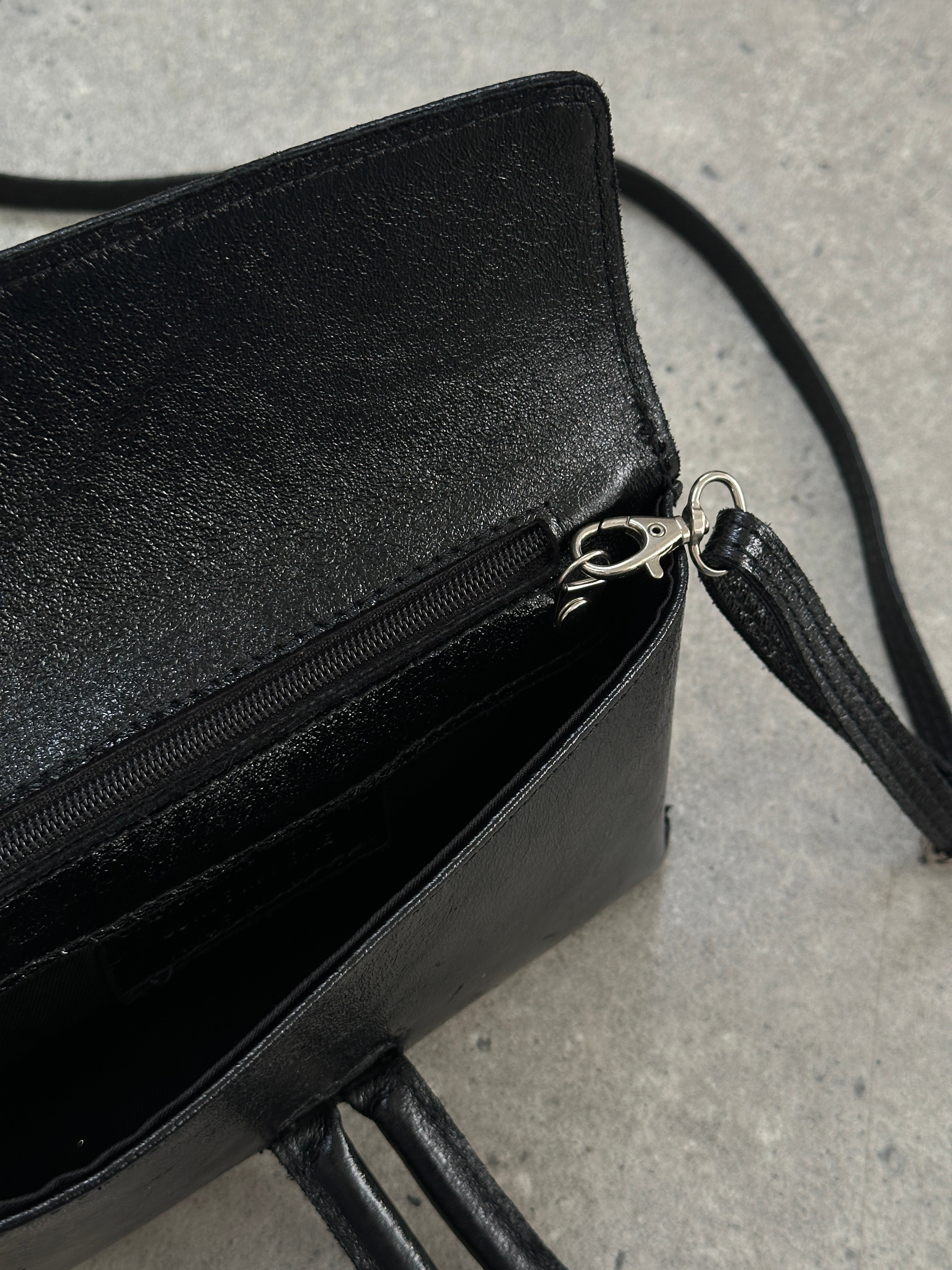 Vintage Italian leather crossbody clutch bag with a classic, distressed finish and compact design, perfect for everyday use.