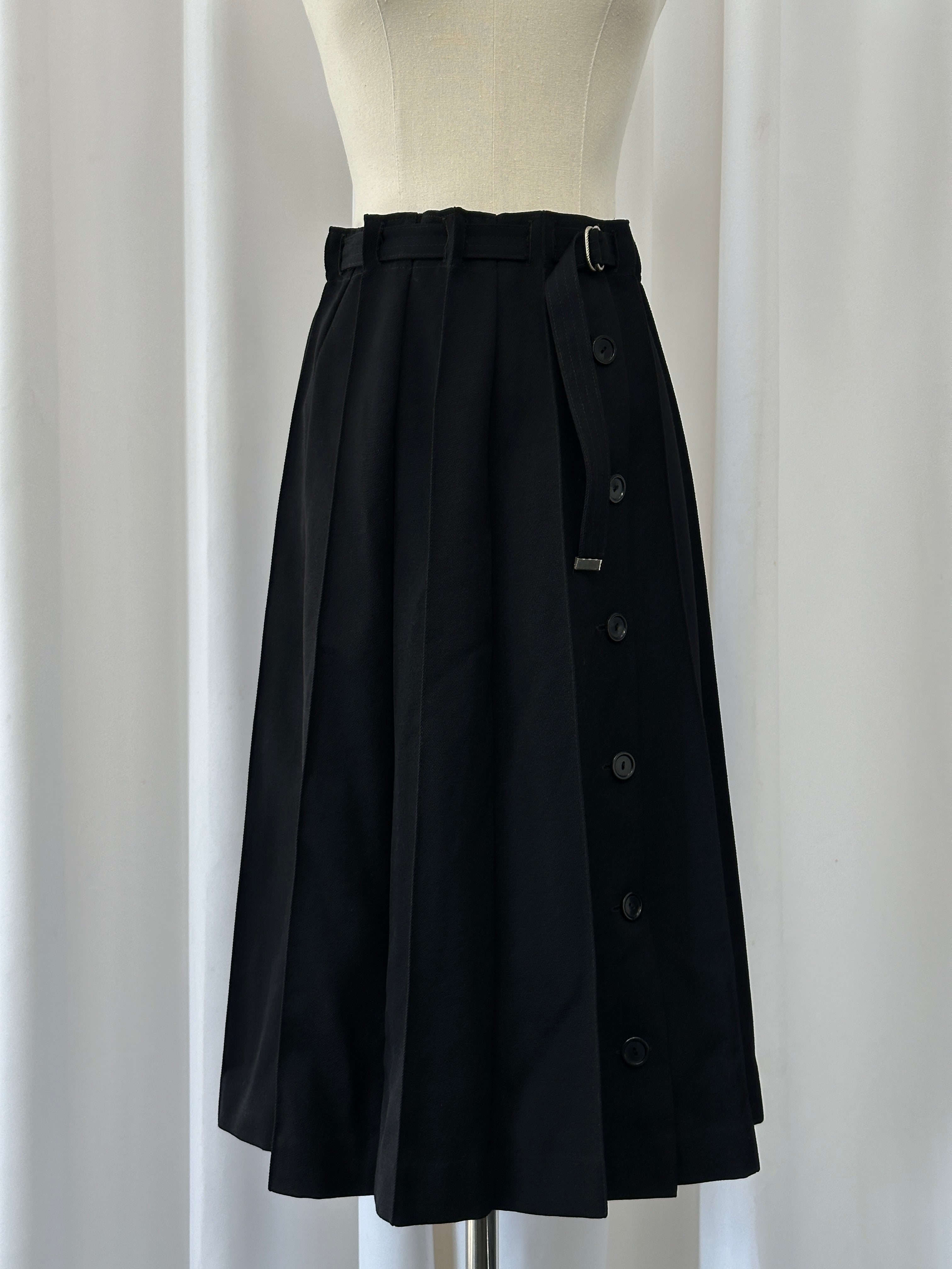 Vintage 1990s wool pleated midi skirt with a high-waist design, featuring classic pleats and a timeless silhouette.