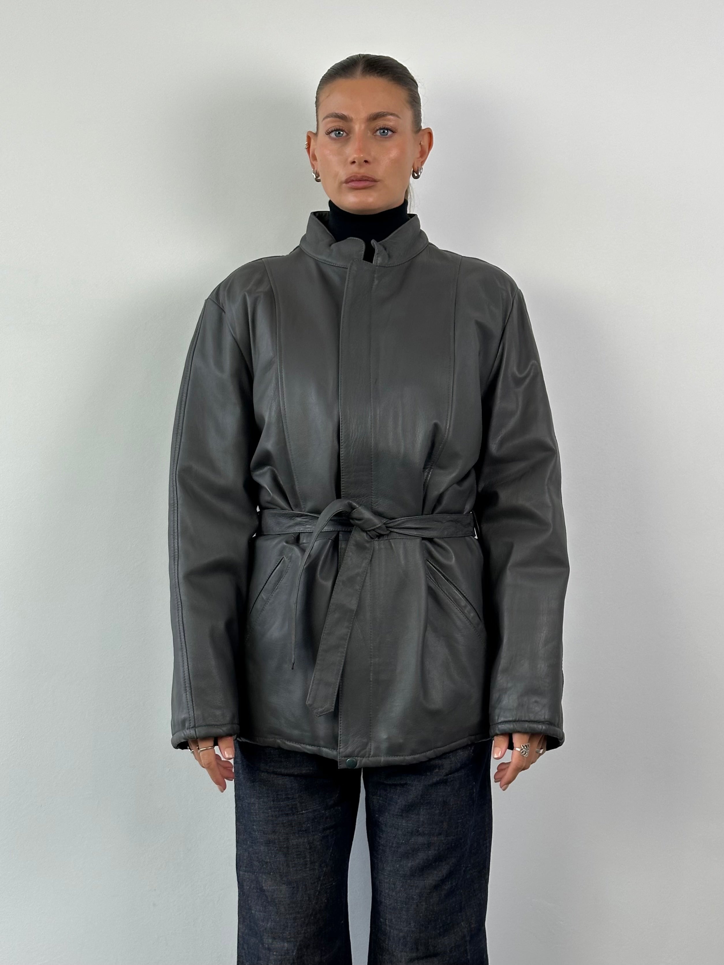 Vintage Italian leather belted jacket, XL size, featuring classic design and detailed stitching, displayed on a hanger.