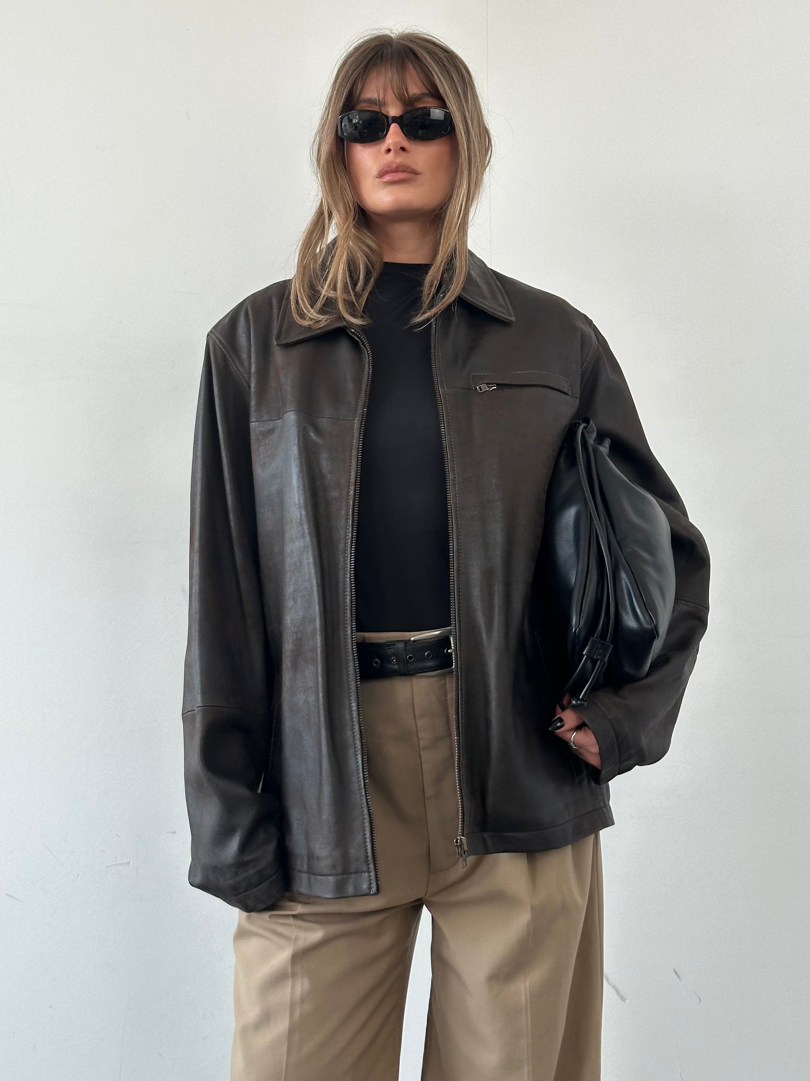 Vintage brand vintage aged leather jacket in XL size, featuring distressed leather and classic style, displayed on a hanger.