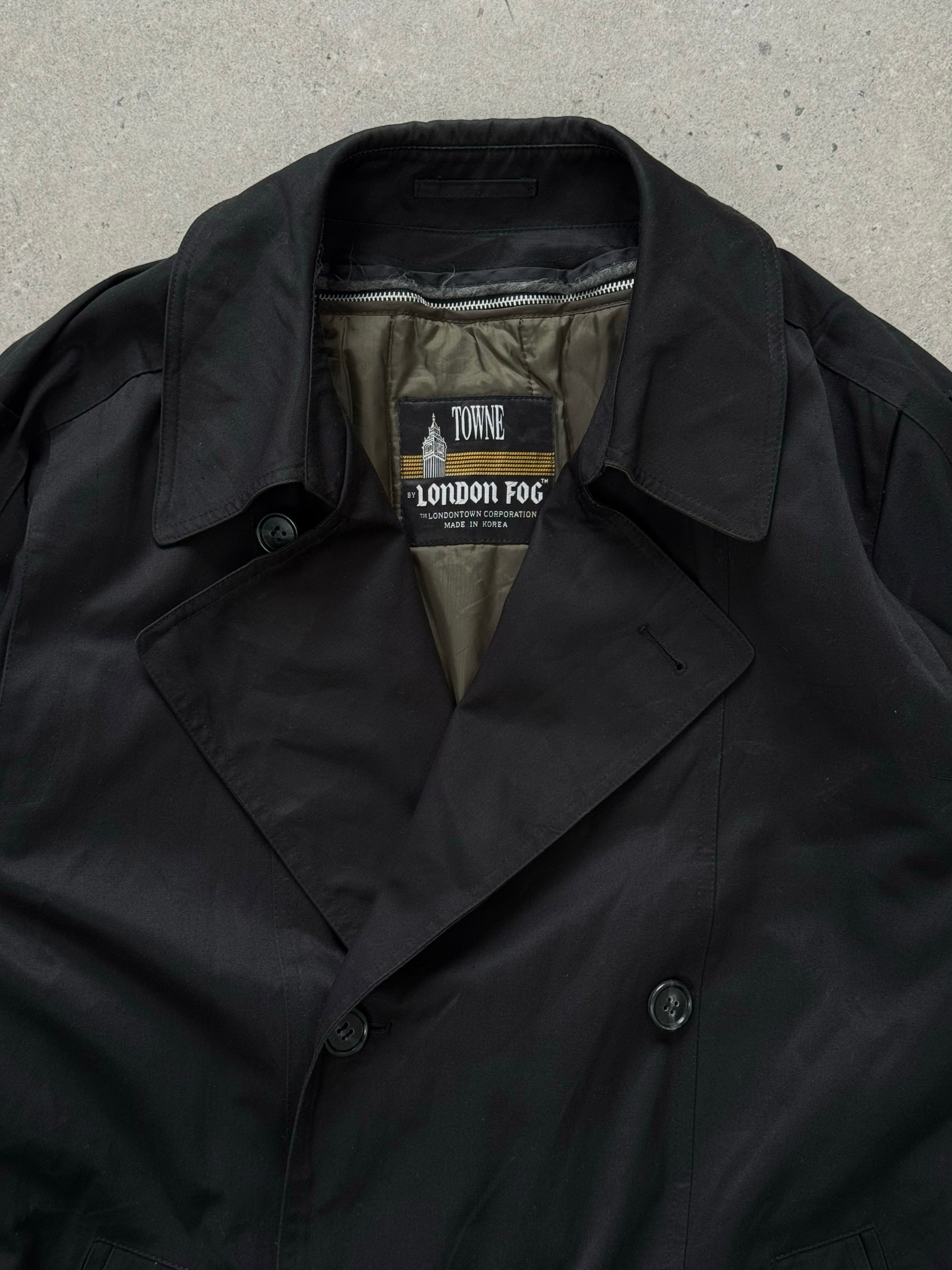 London Fog Towne 1990s double-breasted belted trench coat hanging with a classic design and neutral color.