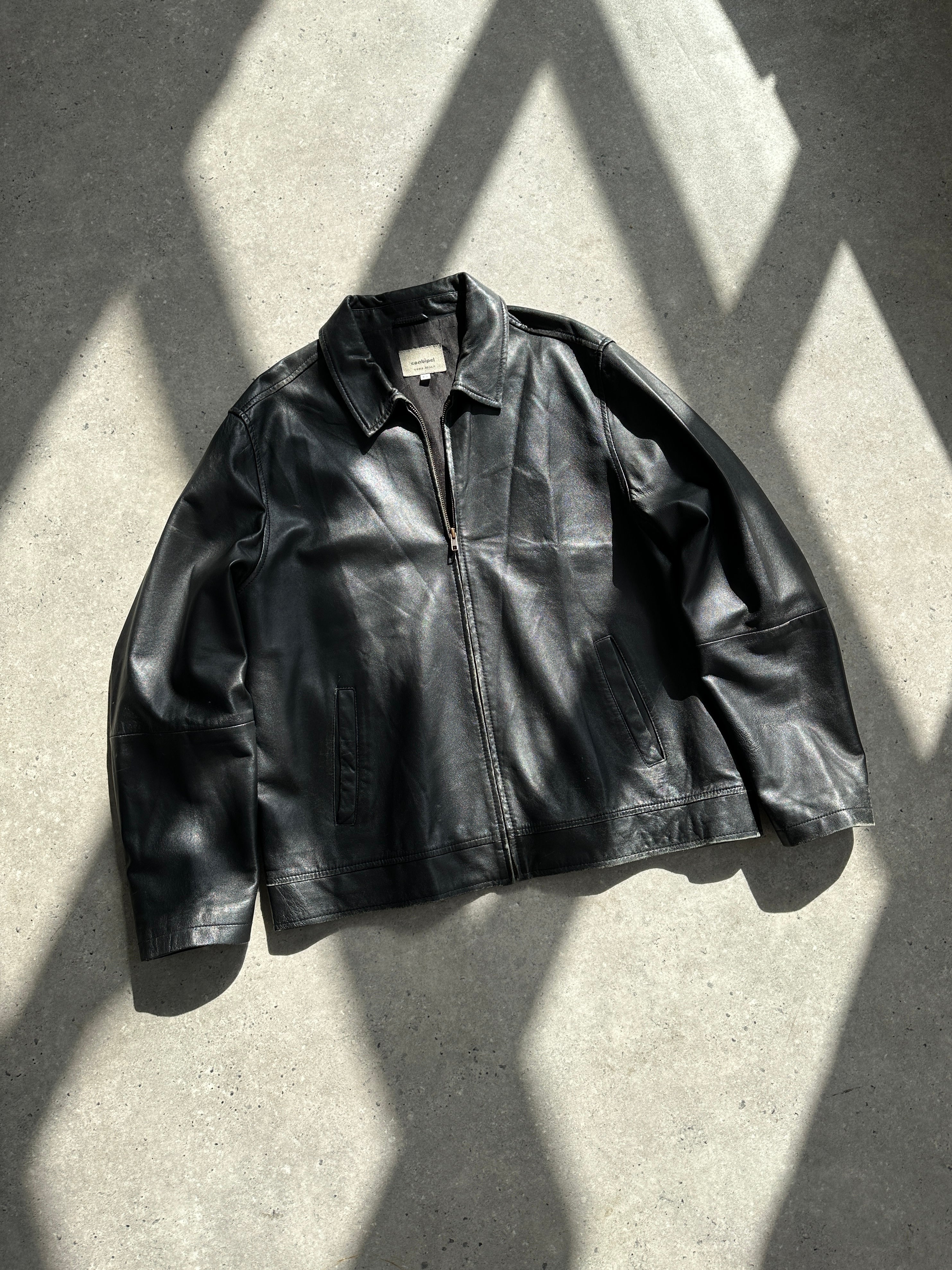 Conbipel minimal leather jacket in size L, featuring sleek design and smooth black leather, displayed on a hanger.