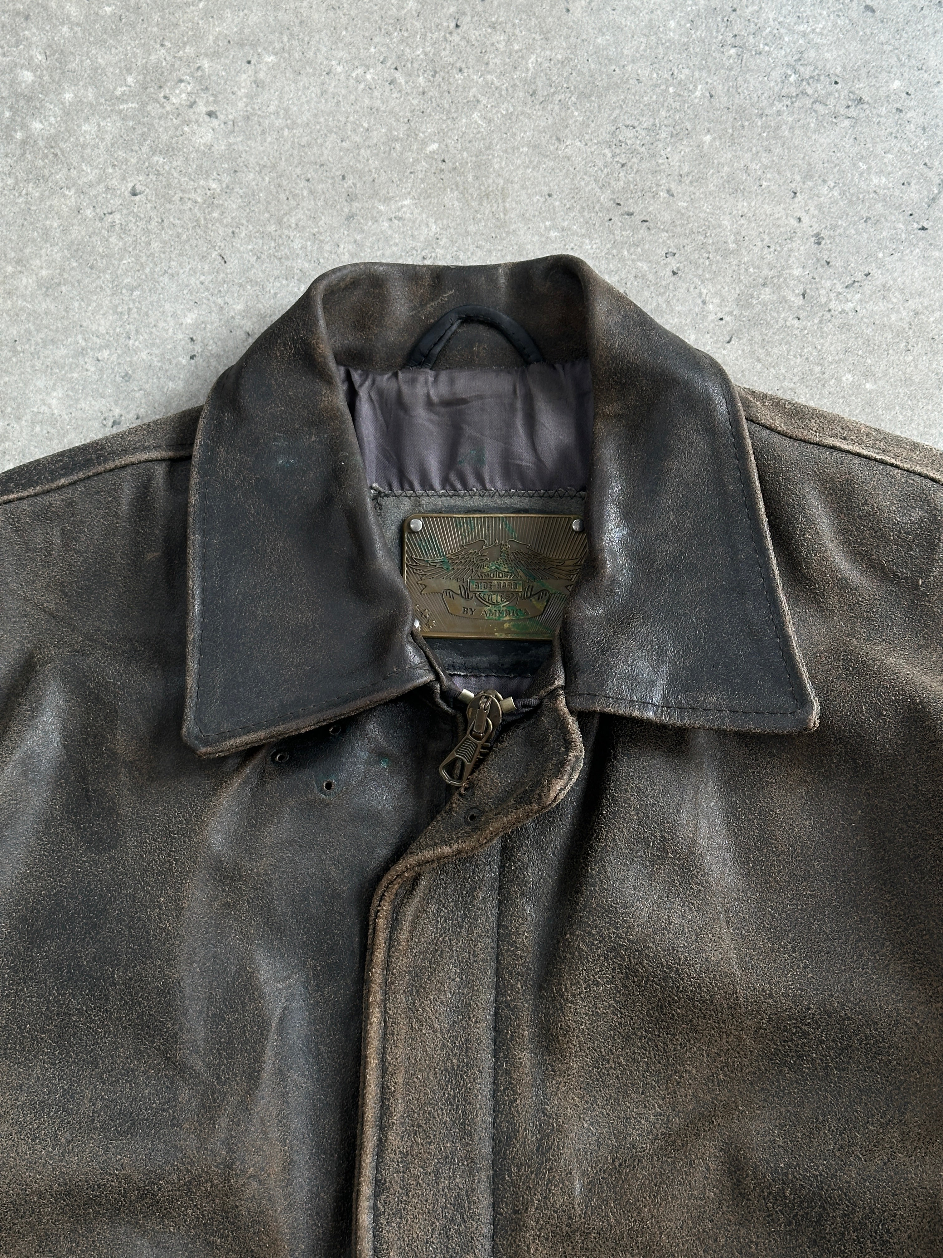 Vintage 1980s distressed leather jacket in XL with rugged, worn look, featuring classic design and natural leather texture.