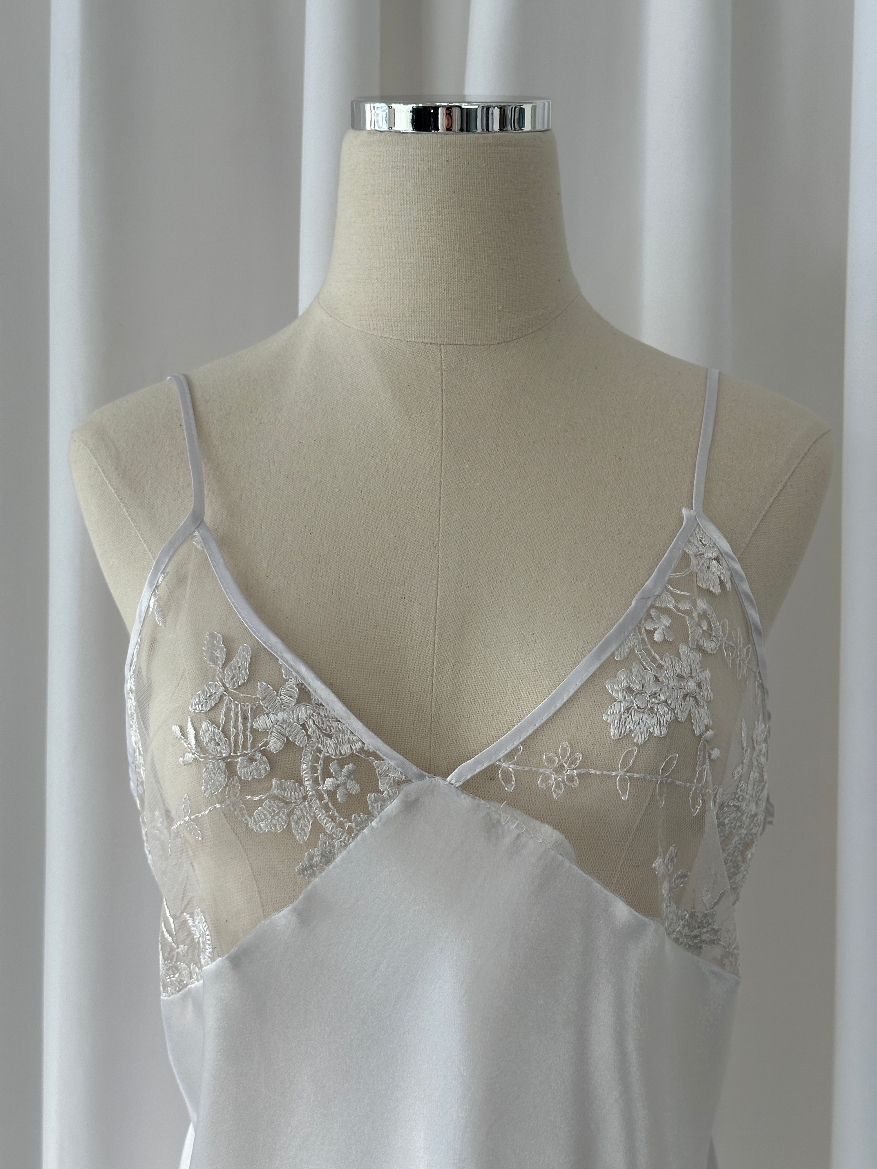 Vintage 1990s lace sheer mini slip dress in M/L, featuring delicate lace fabric and a vintage-inspired design.