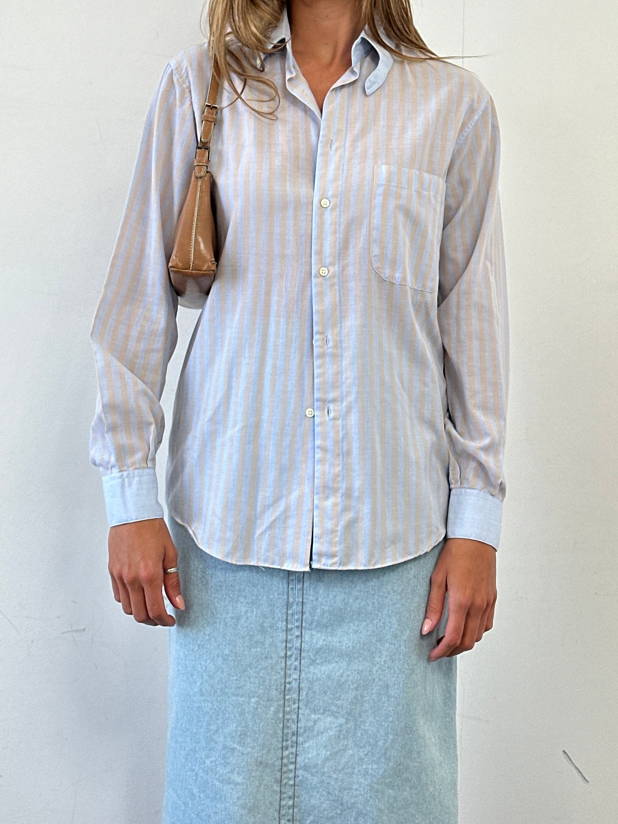 Vintage striped cotton shirt in size M, featuring classic design and button-up front, displayed on a hanger.