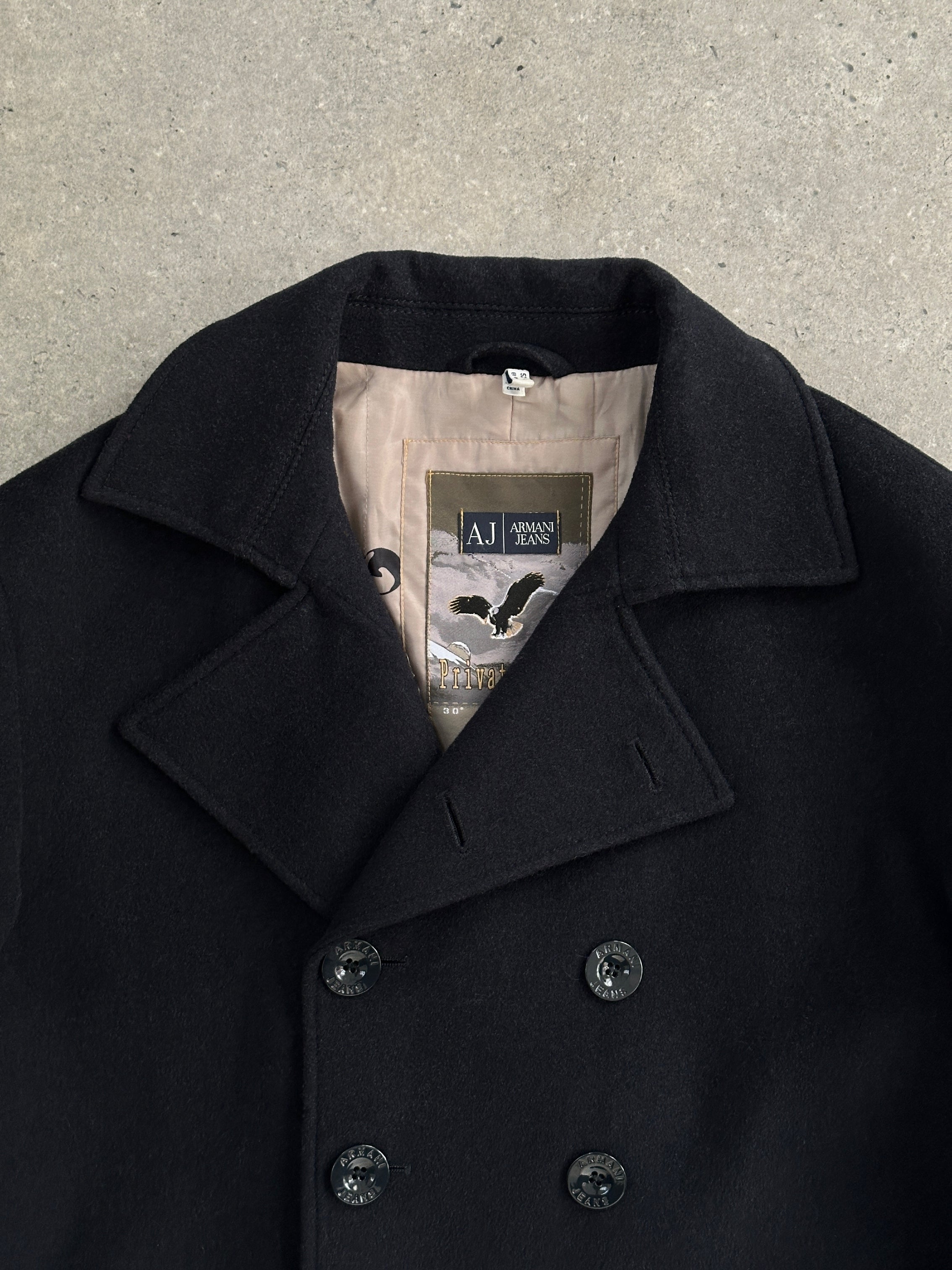 Armani Jeans wool double-breasted coat in size XL, featuring a classic design and tailored fit, shown on a hanger.