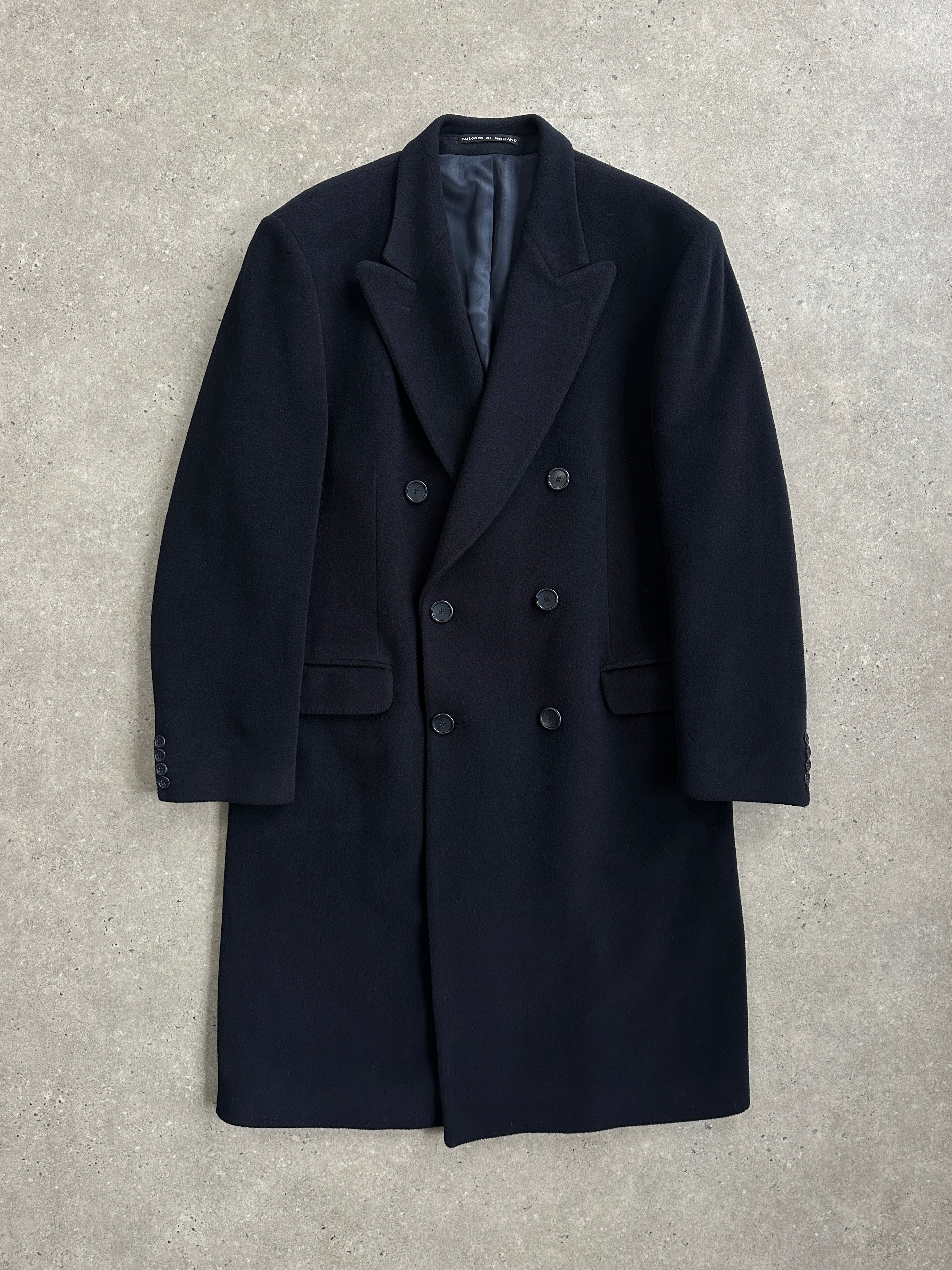 Vintage British 1990s wool and cashmere double-breasted coat in XL with classic design and tailored fit, displayed on a hanger.