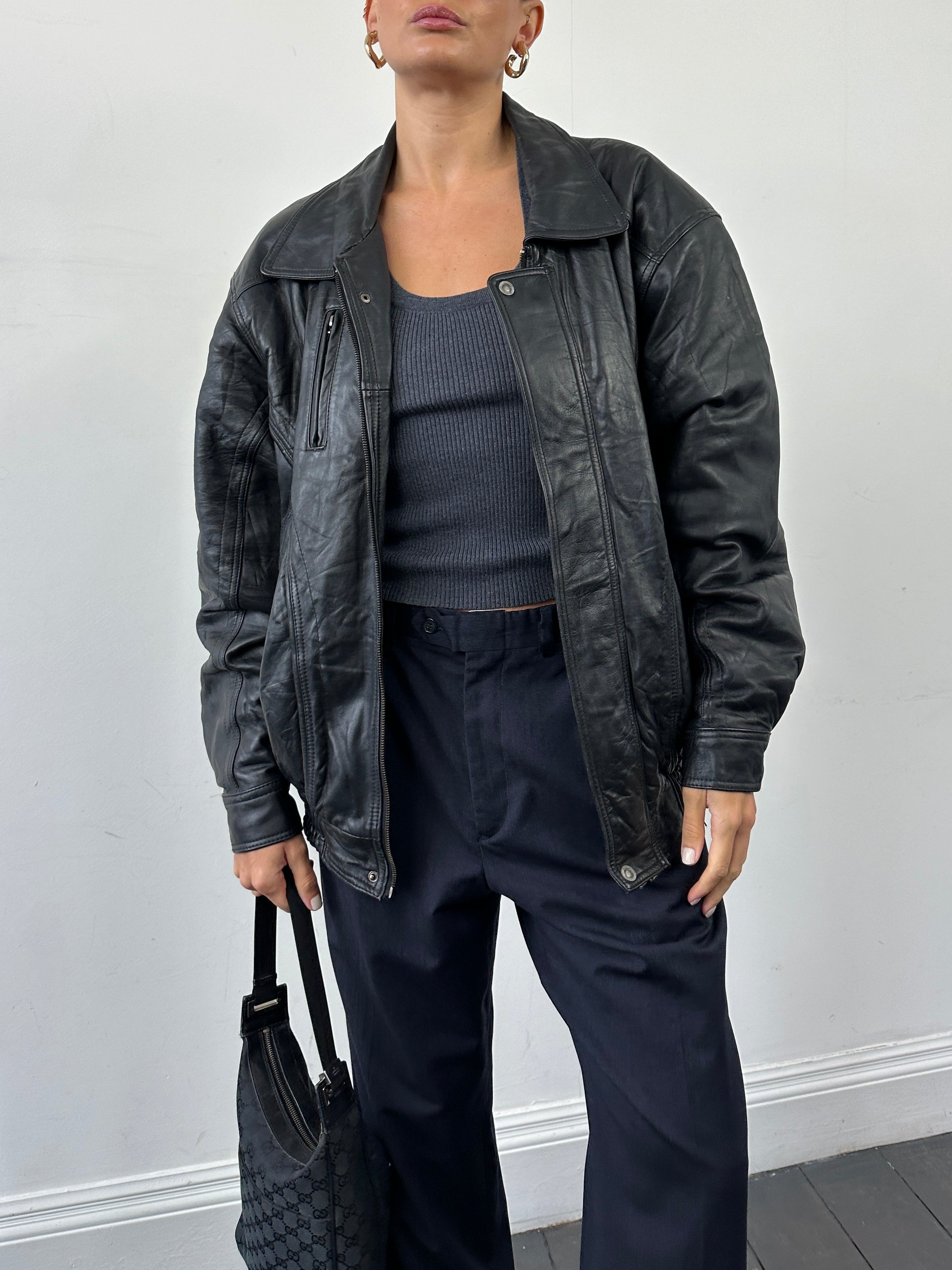 Vintage leather bomber jacket in size XL, featuring classic design, ribbed cuffs, and a smooth leather finish.