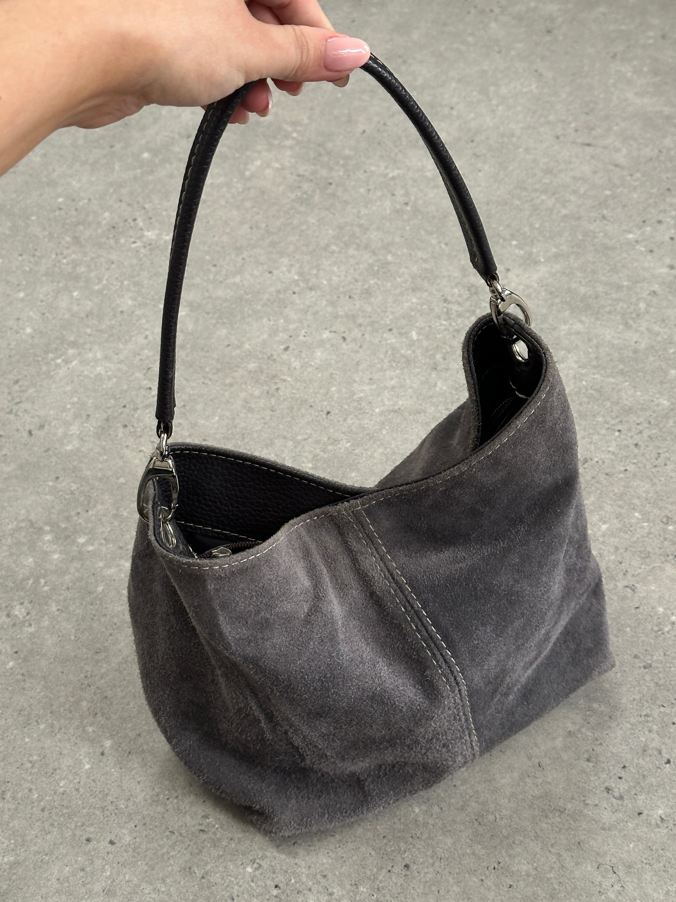 Vintage suede leather shoulder bag with adjustable strap and minimalist design, perfect for casual or stylish everyday use.