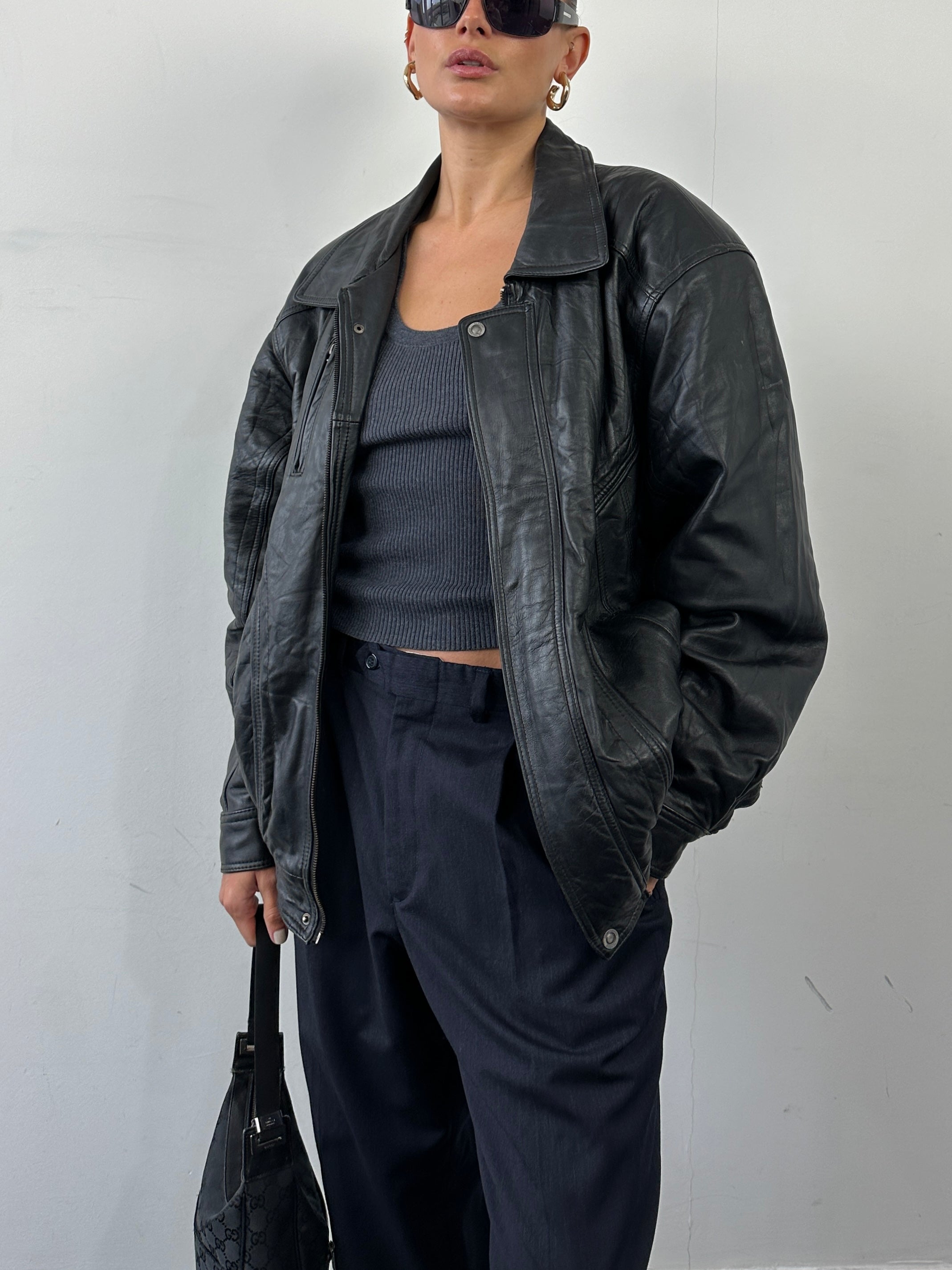 Vintage leather bomber jacket in XL size, featuring classic design with a worn-in look and detailed stitching.