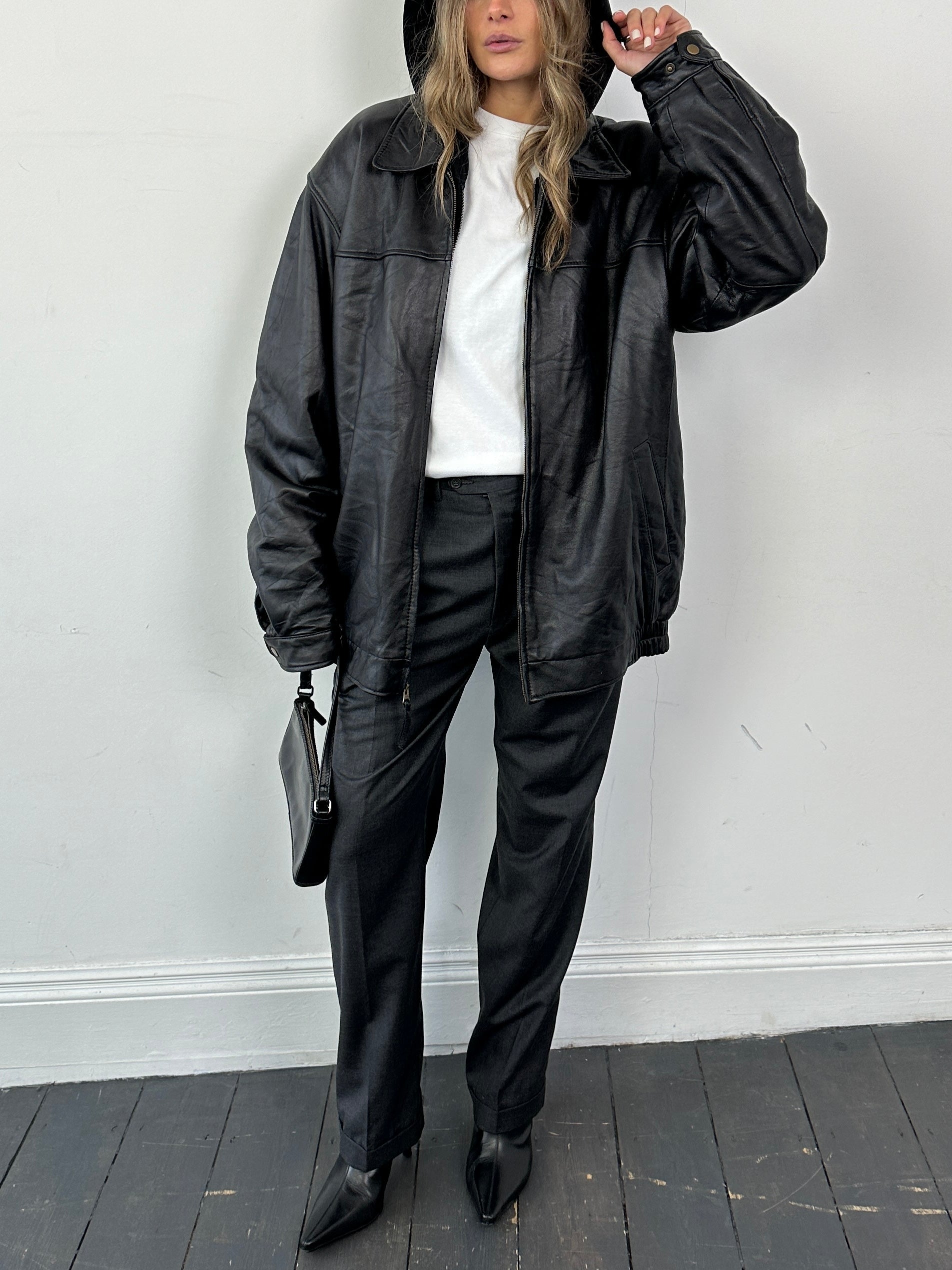 Vintage minimal leather bomber jacket in XL/XXL with sleek design, showcased on a hanger.
