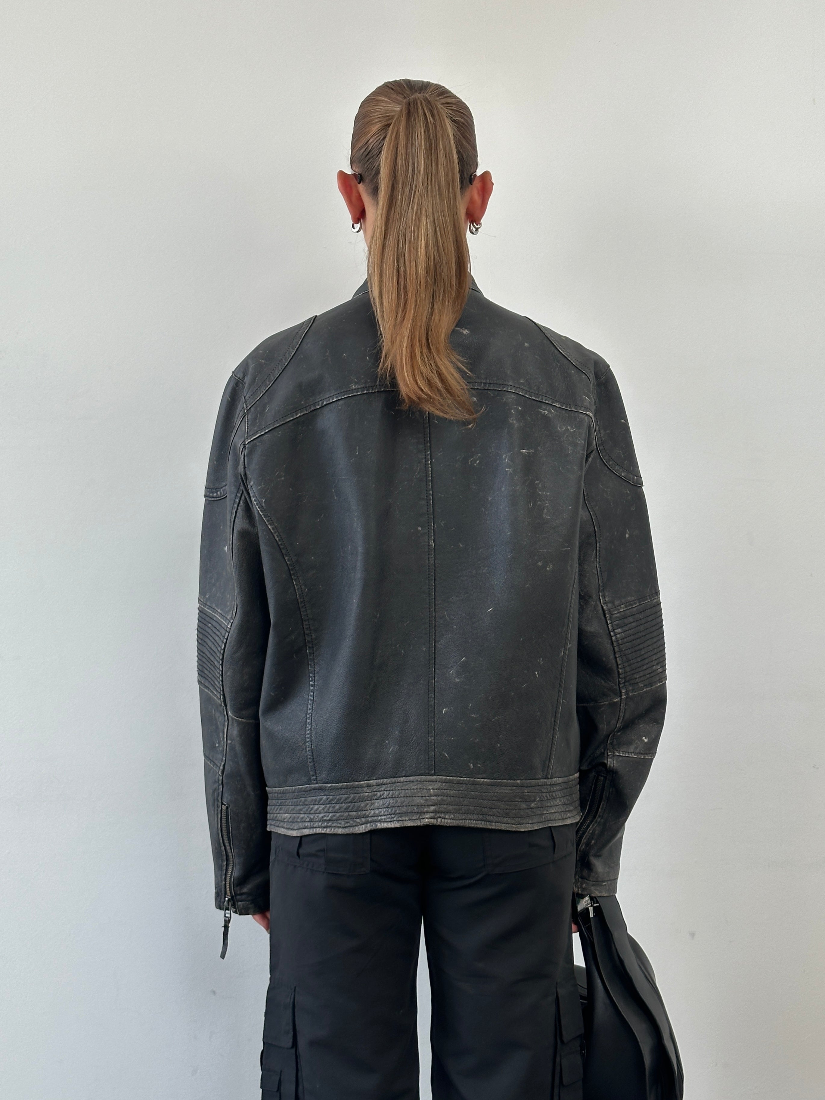 Vintage distressed leather moto jacket in size M/L, featuring classic biker style with rugged, worn-in leather detailing.