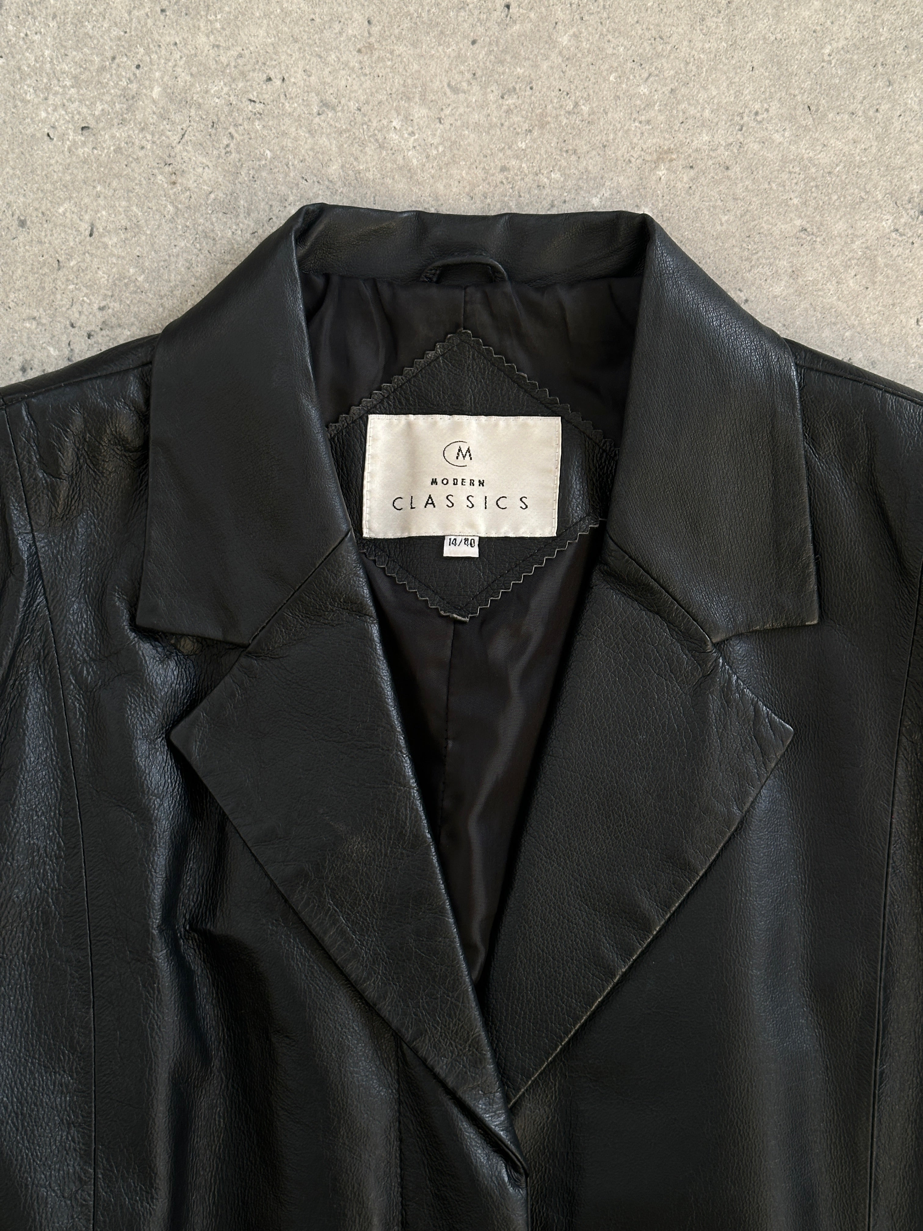 Vintage 2000s leather jacket with rope tie belt, medium size, showcasing classic design and textured leather material.