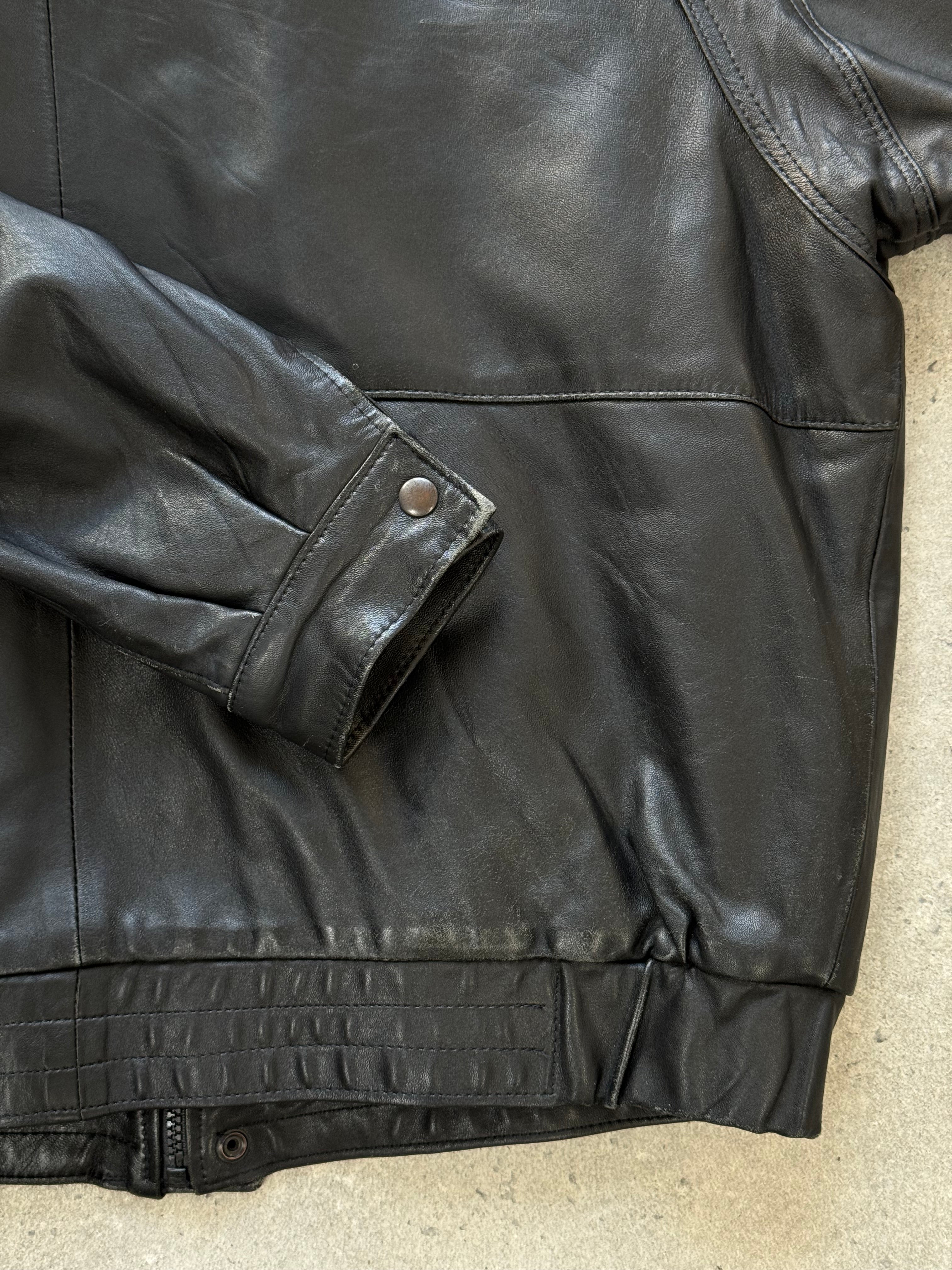 Vintage 1990s leather bomber jacket in XL size, featuring classic design and durable brown leather, styled for casual wear.