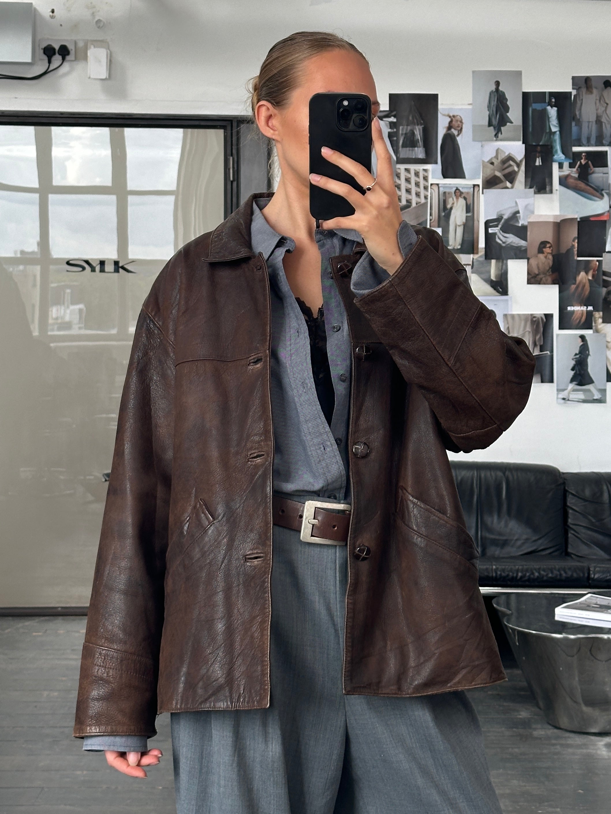 Vintage 1980s boxy leather jacket in aged brown leather, size XL, featuring classic design and textured distressed finish.