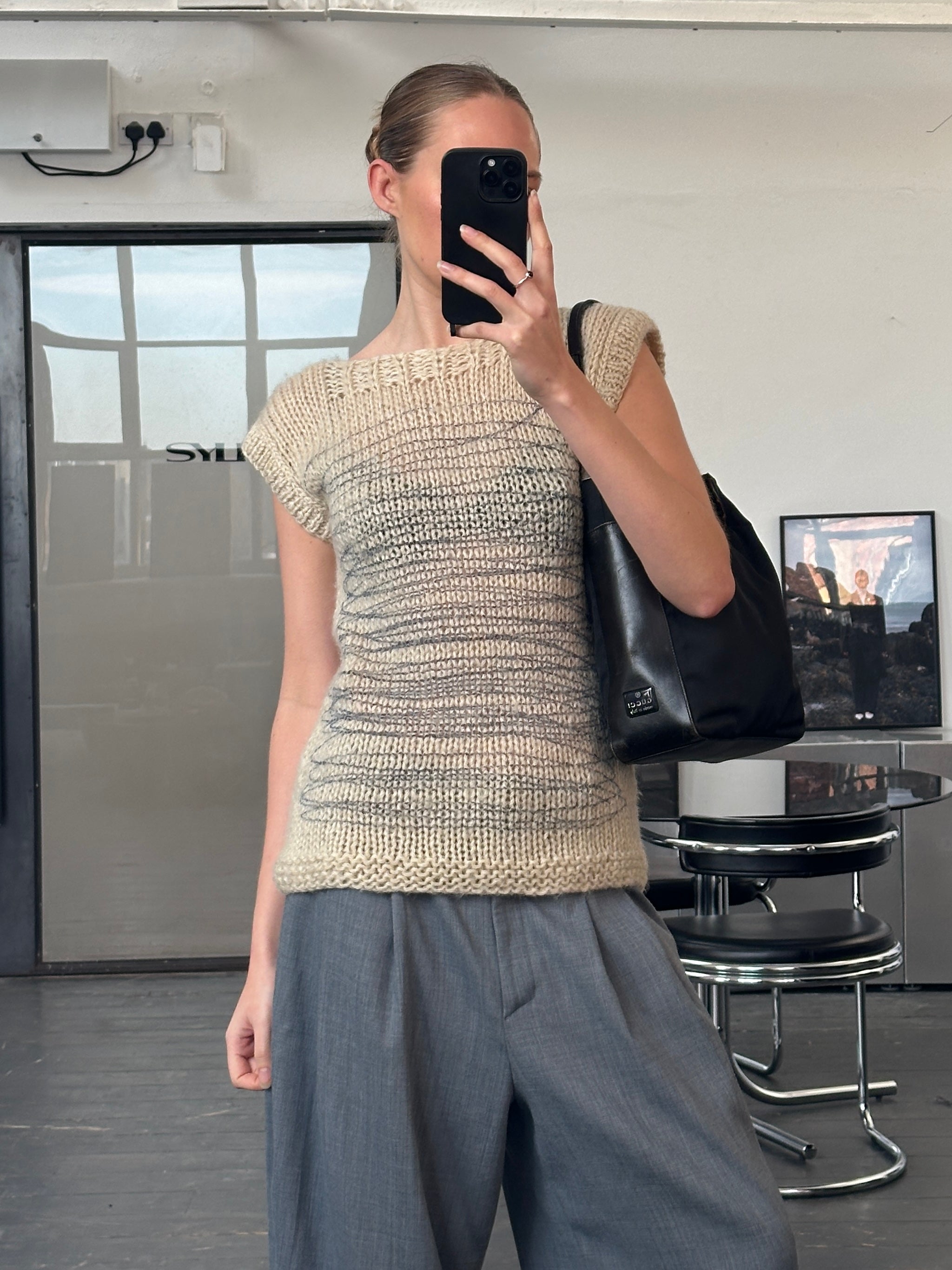 Vintage 1980s abstract wool knitted jumper sweater in size M, featuring colorful geometric patterns and a cozy textured design.