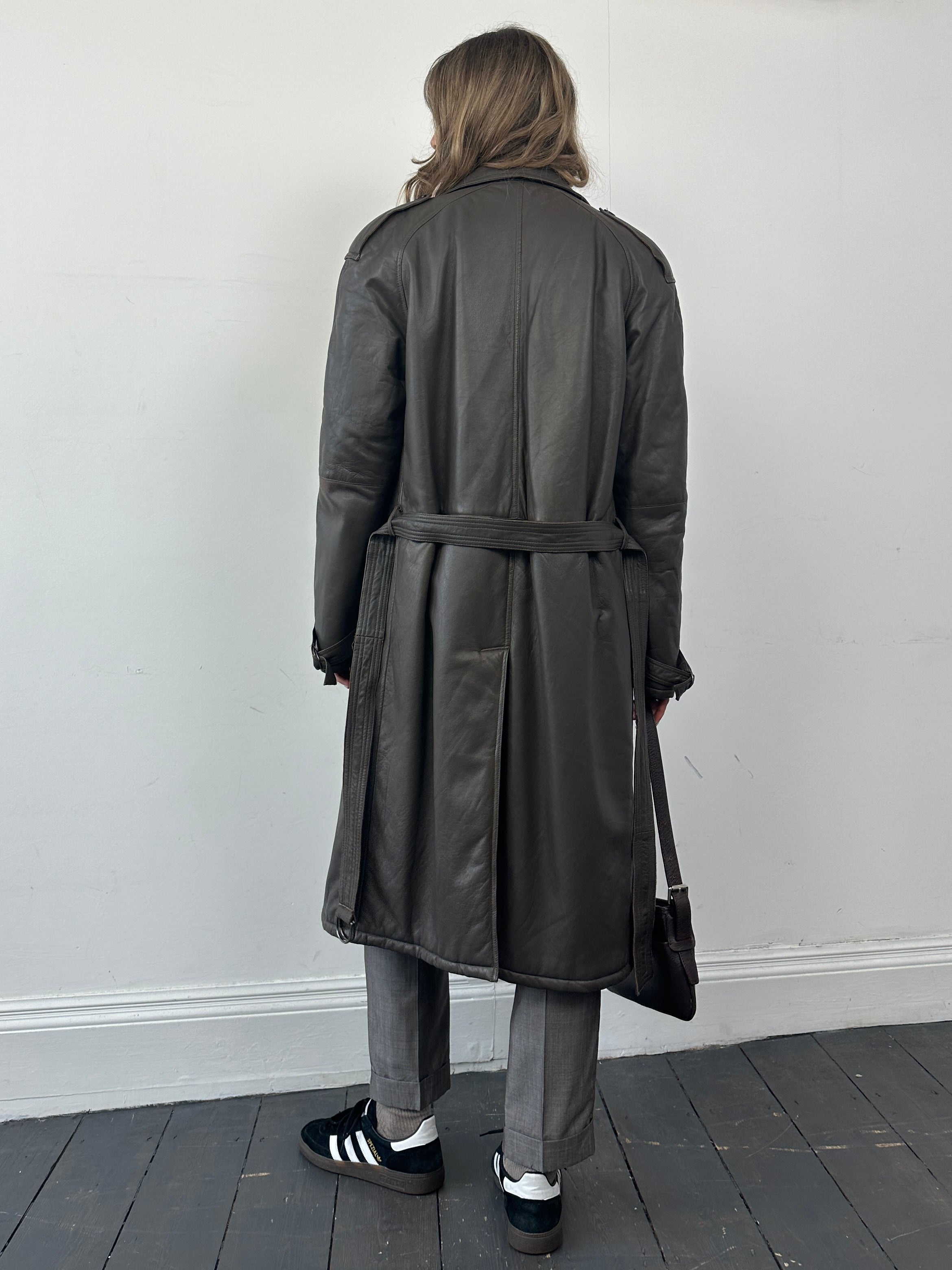 Vintage leather double-breasted trench coat with belted waist, tailored fit, and classic style in size large.