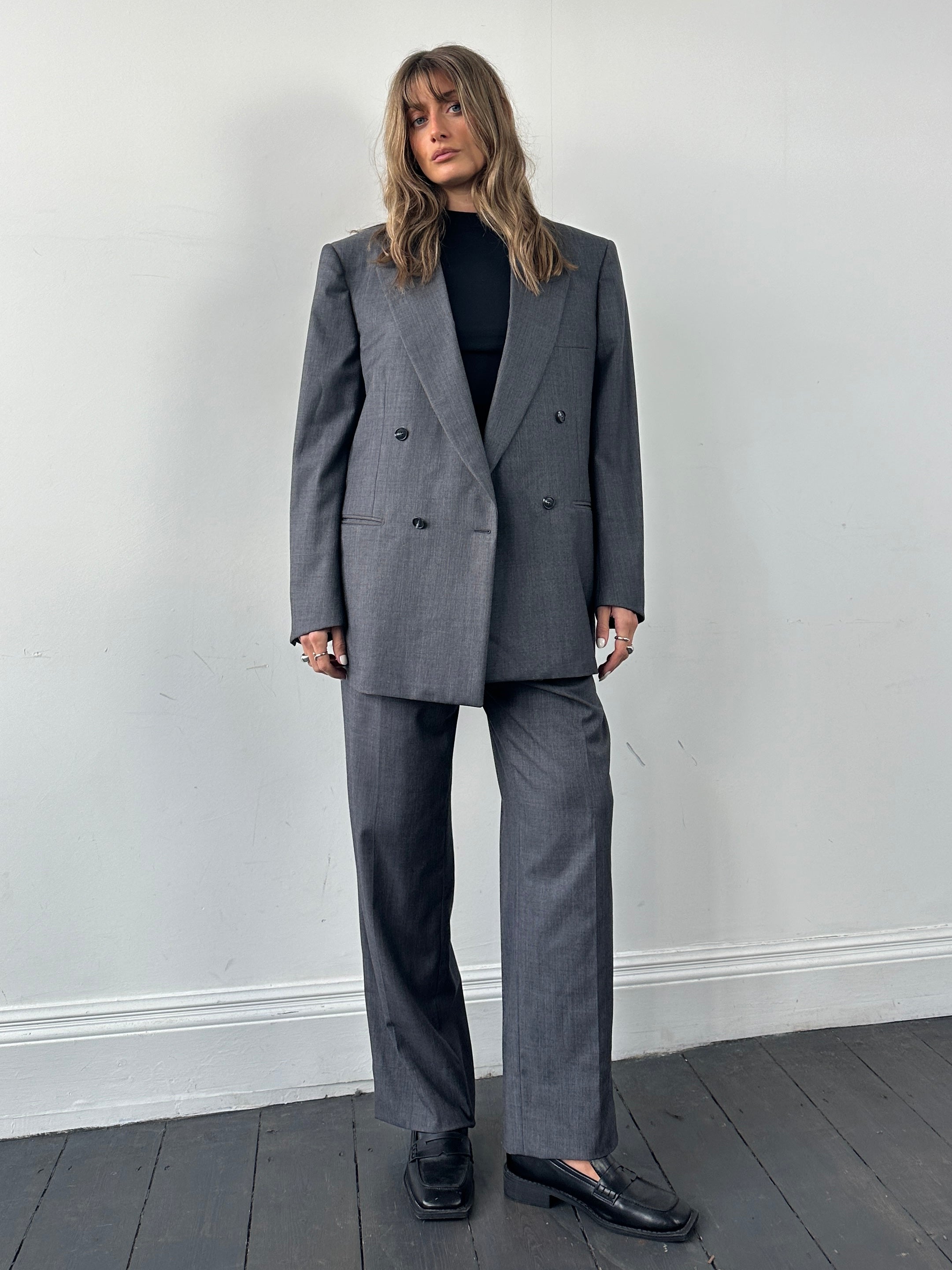 Christian Dior pure wool double-breasted jumpsuit in size 44S/W34, tailored fit with lapel collar and front button closure.