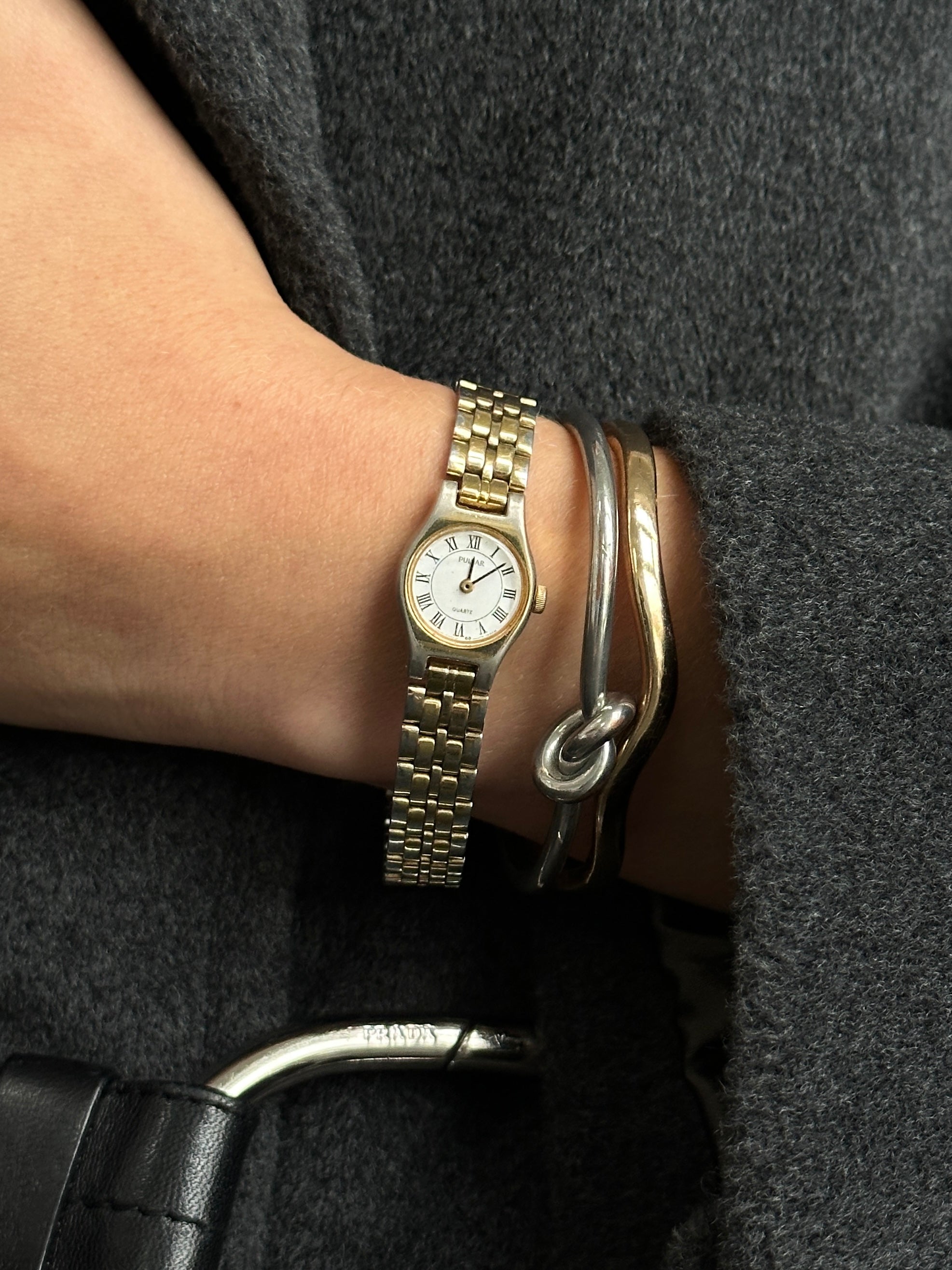 Pulsar 1990s two-tone round quartz watch with silver and gold accents, metal band, and classic dial design.