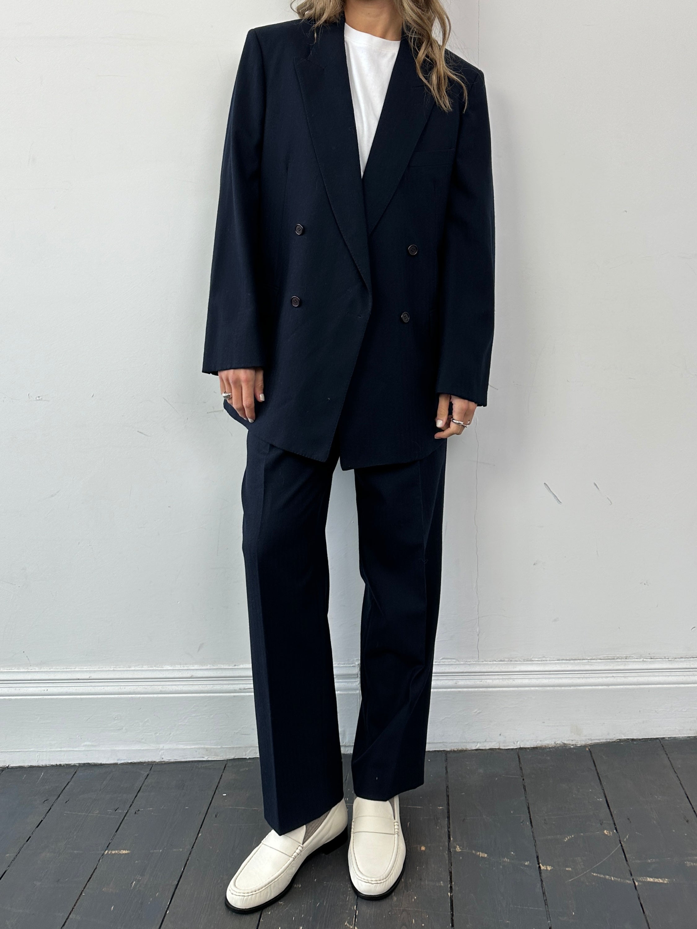 Christian Dior double-breasted wool jumpsuit in size 43R/W32, tailored fit with lapel collar and structured design.