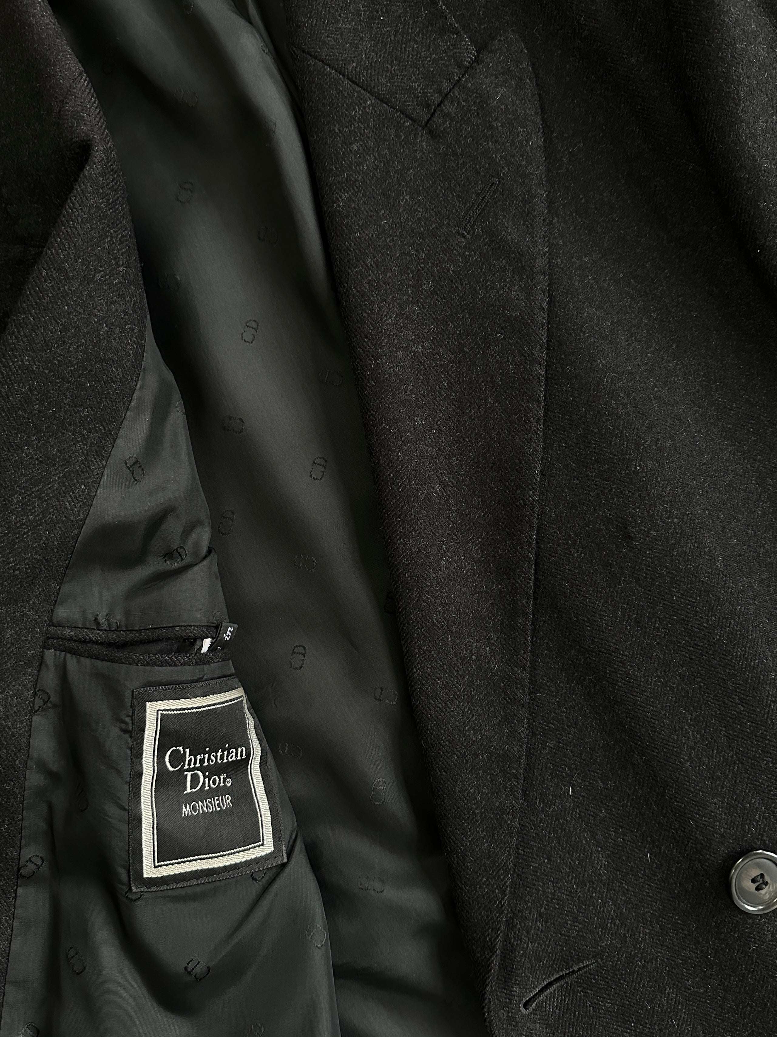 Christian Dior pure wool double-breasted coat in size L/XL, shown on a hanger with classic tailored design and elegant lapels.