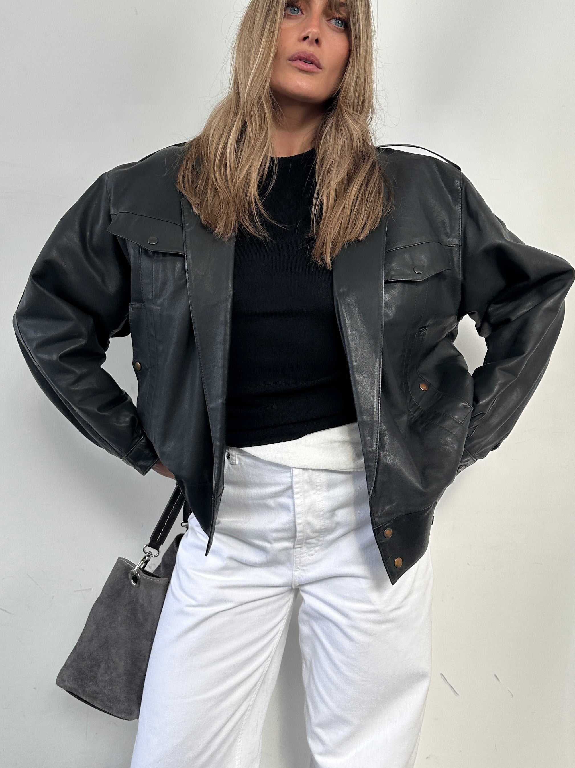 Vintage leather bomber jacket for men, size small, featuring classic design, front zipper, and ribbed cuffs and collar.