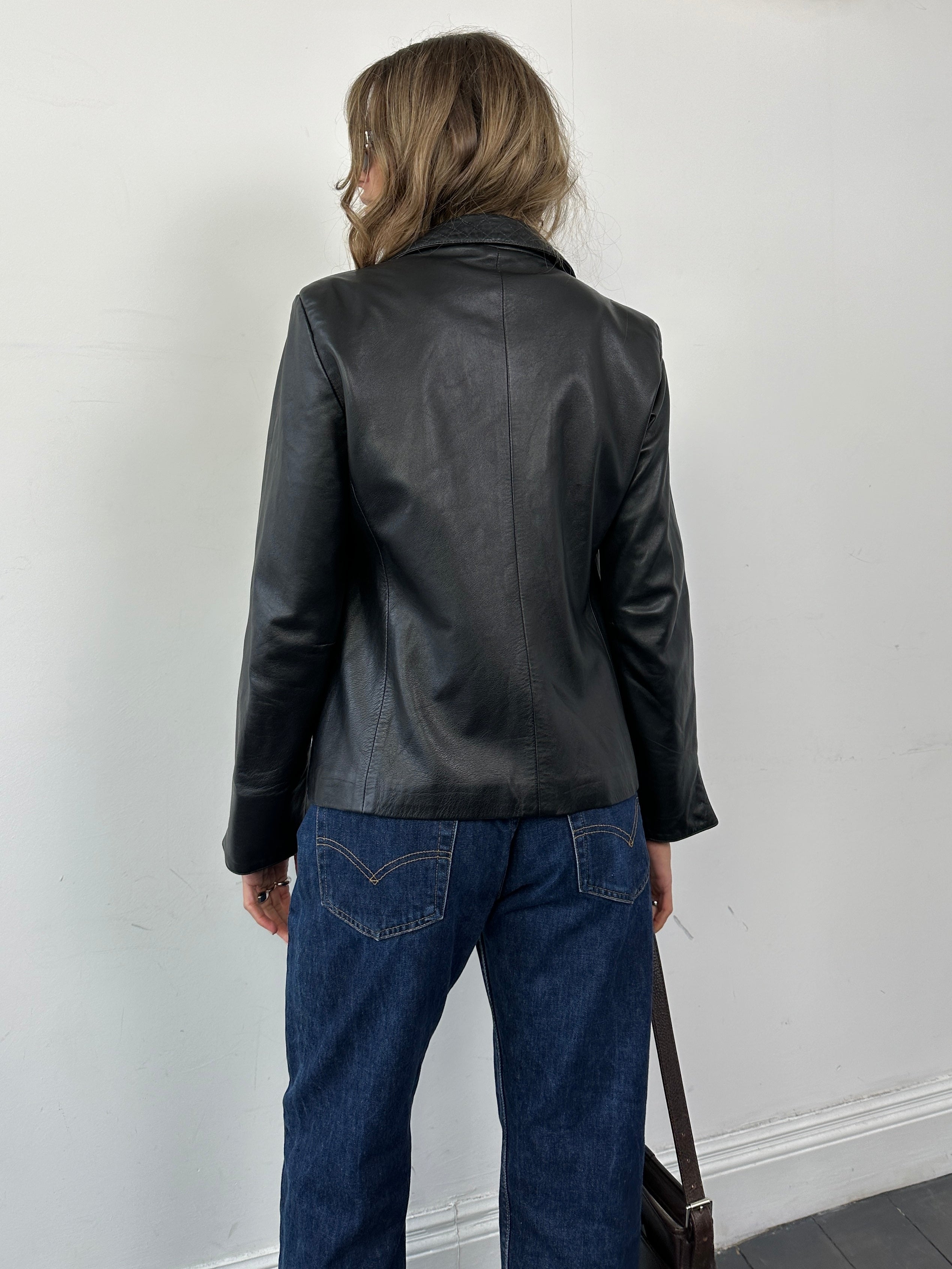 Vintage Italian vintage leather jacket in size small, featuring classic design and rich leather texture.
