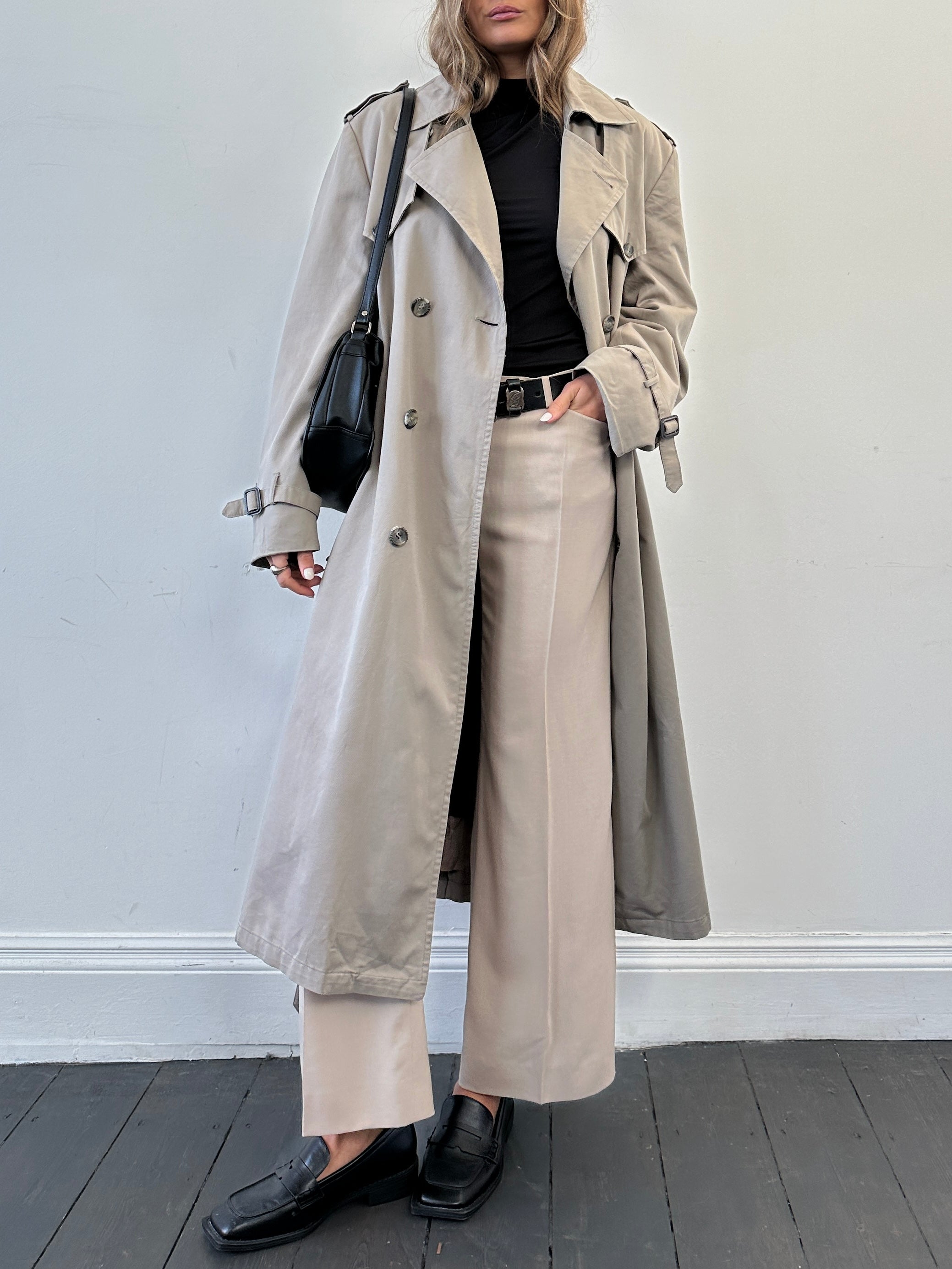 Christian Dior double-breasted cotton trench coat in size L/XL, showing classic design with belt and tailored fit.