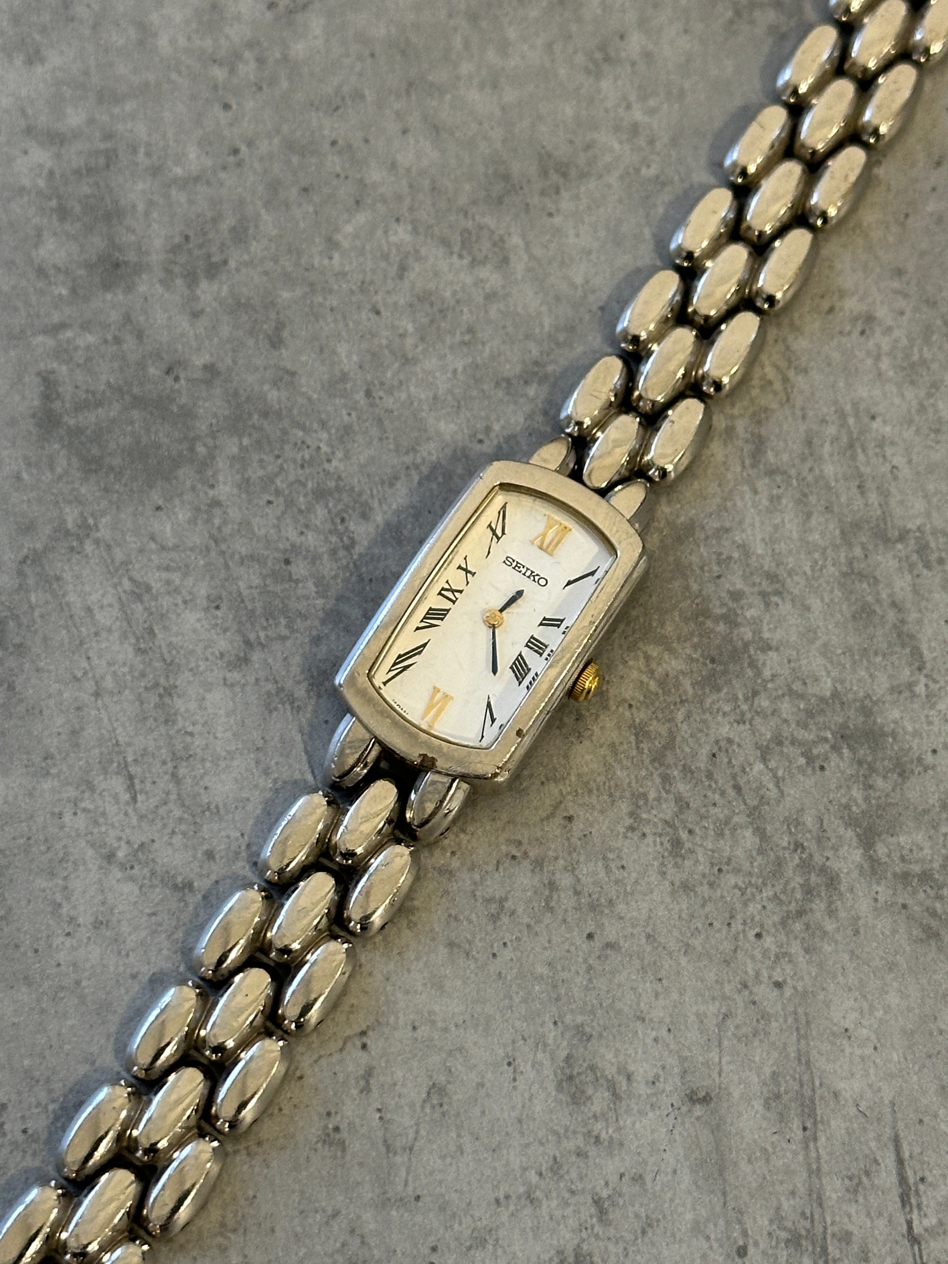 Seiko 1990s stainless steel rectangular quartz watch with a sleek design and classic silver finish.